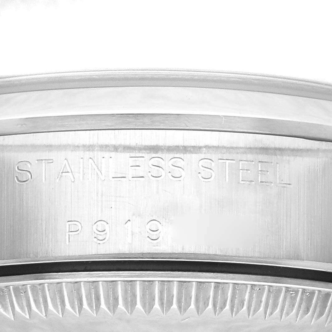 The image shows a close-up of the case back engraving of a Rolex Oyster Perpetual 76080 Women's Stainless Steel Black Dial 76080 Women's Stainless Steel Black Dial, highlighting the "STAINLESS STEEL" text.