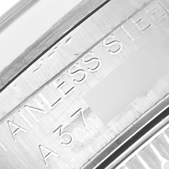 This close-up image shows the stainless steel engraving on the inner bezel of a Rolex Oyster Perpetual 76080 Women's Stainless Steel Blue Dial 76080 Women's Stainless Steel Blue Dial watch.