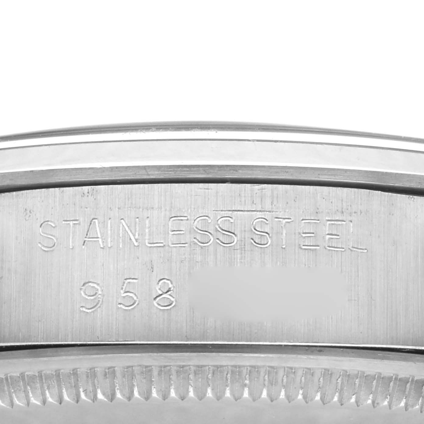 This image shows a close-up of the side casing of the Rolex Vintage Collection 1002 Men's Stainless Steel Silver Dial 1002 Men's Stainless Steel Silver Dial watch displaying "STAINLESS STEEL" and a partial serial number.