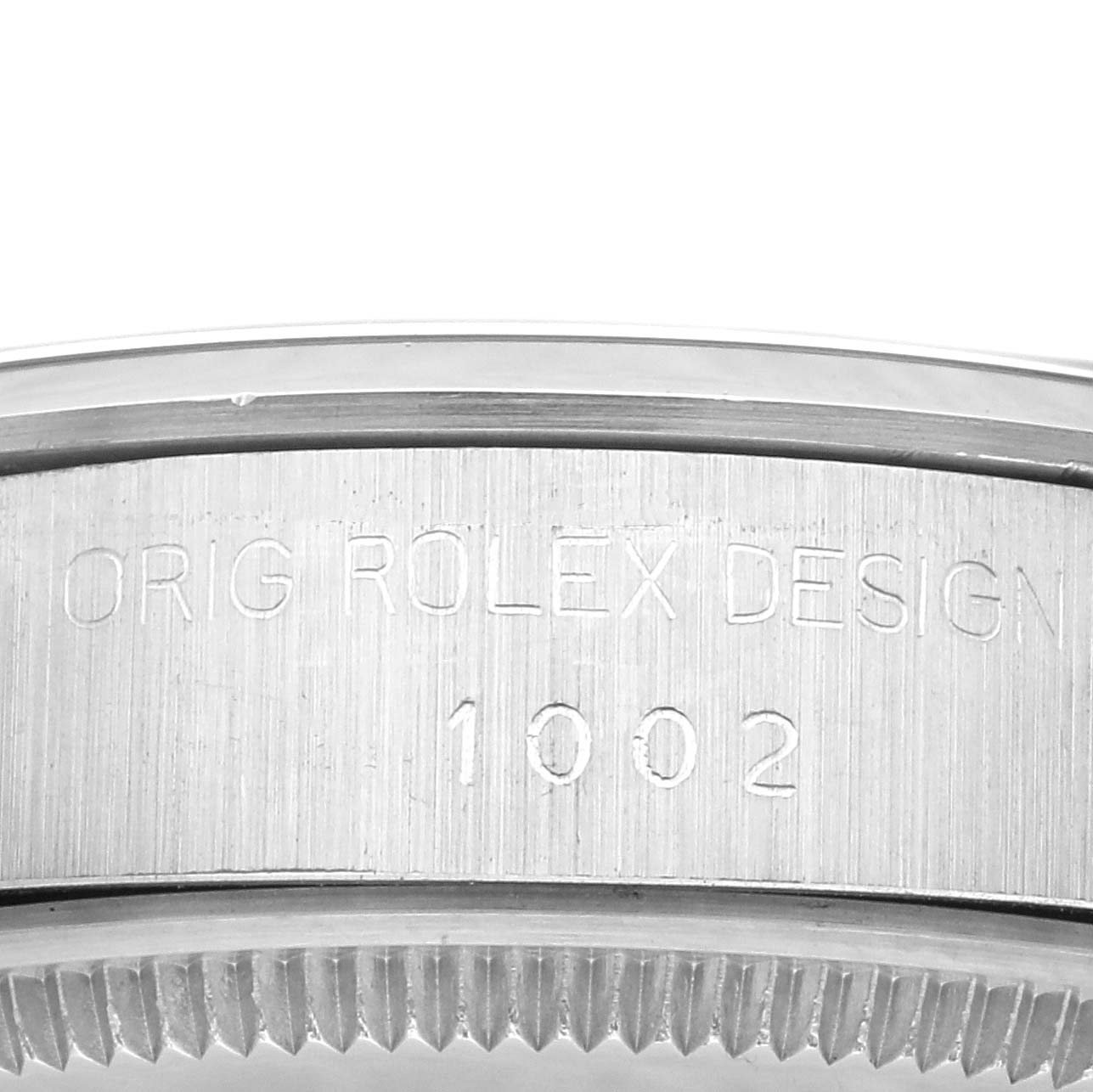 The image shows a close-up of the side case of a Vintage Collection Rolex watch, focusing on the engraved "ORIG ROLEX DESIGN" and model number "1002."