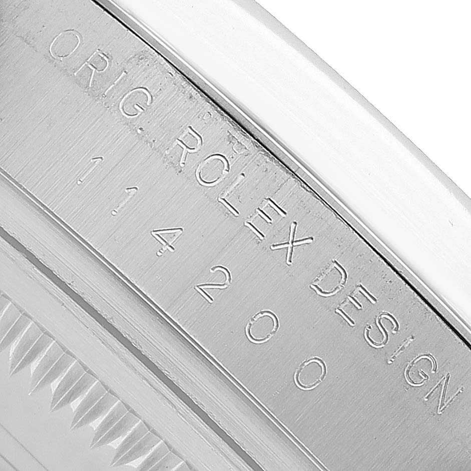 The image shows a close-up side angle of the case back, featuring the engraving "ORIG. ROLEX DESIGN" on the Oyster Perpetual by Rolex.