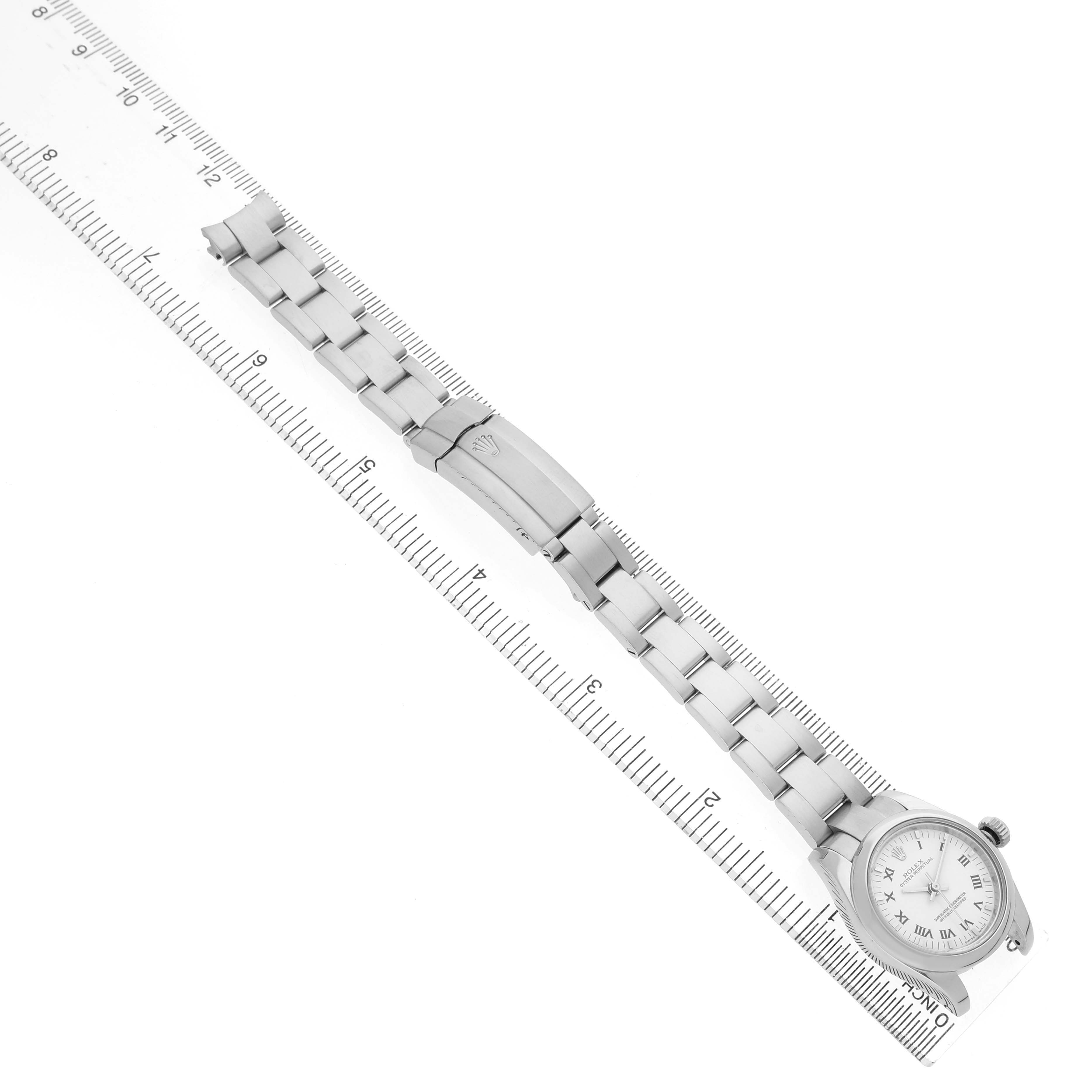 The Rolex Oyster Perpetual 176200 Women's Stainless Steel White Dial watch is shown from a top-down angle, highlighting the full bracelet, clasp, and dial.