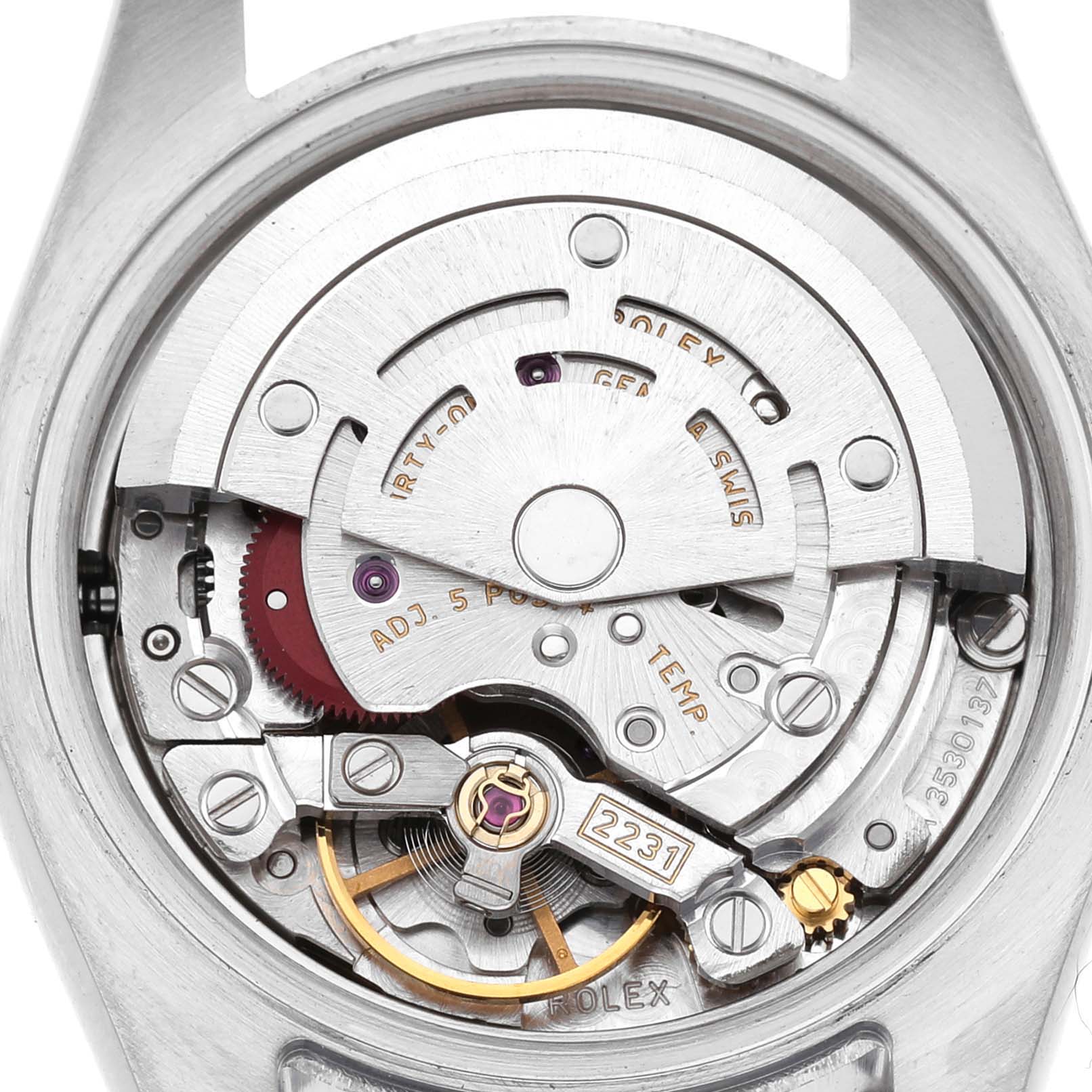 The image shows the movement and inner mechanism of a Rolex Oyster Perpetual 176200 Women's Stainless Steel White Dial watch from a rear angle, revealing intricate details.