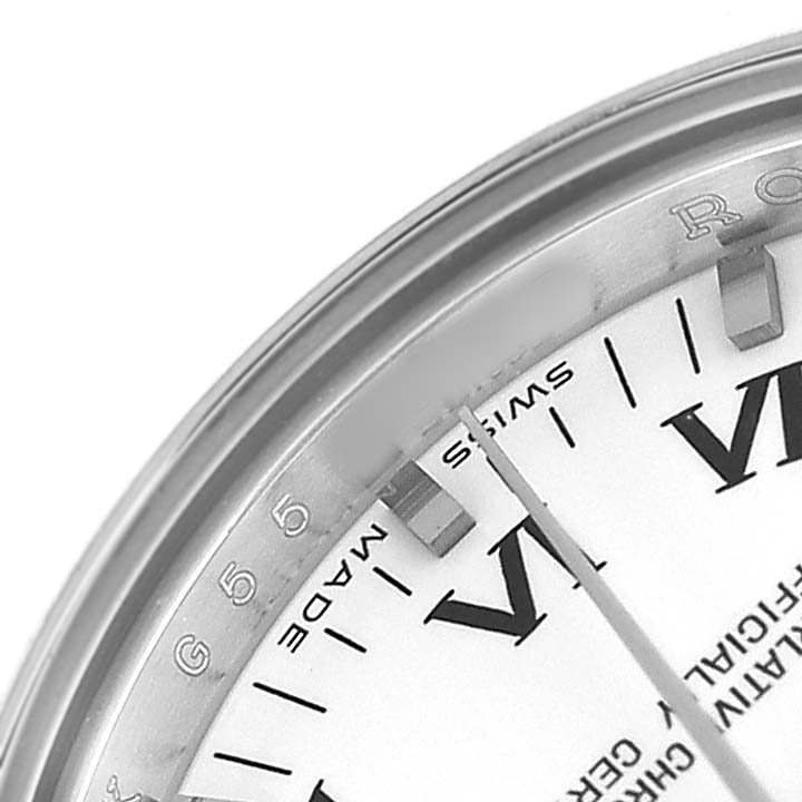 This close-up of the Rolex Oyster Perpetual 176200 Women's Stainless Steel White Dial shows part of the bezel, indices, and the edge of the dial with "SWISS MADE."
