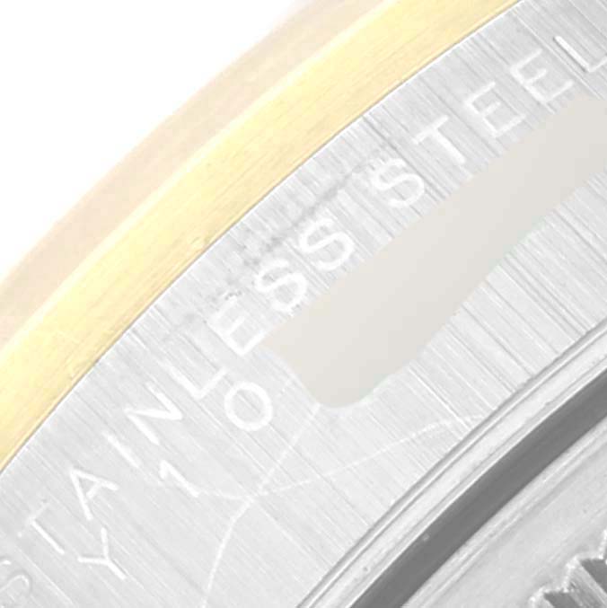 The image showcases a close-up of the bezel and part of the casing of a Rolex Oyster Perpetual 14203 Men's Steel and Gold (two tone) Grey Dial 14203 Men's Steel and Gold (two tone) Grey Dial watch, highlighting the "STAINLESS STEEL."