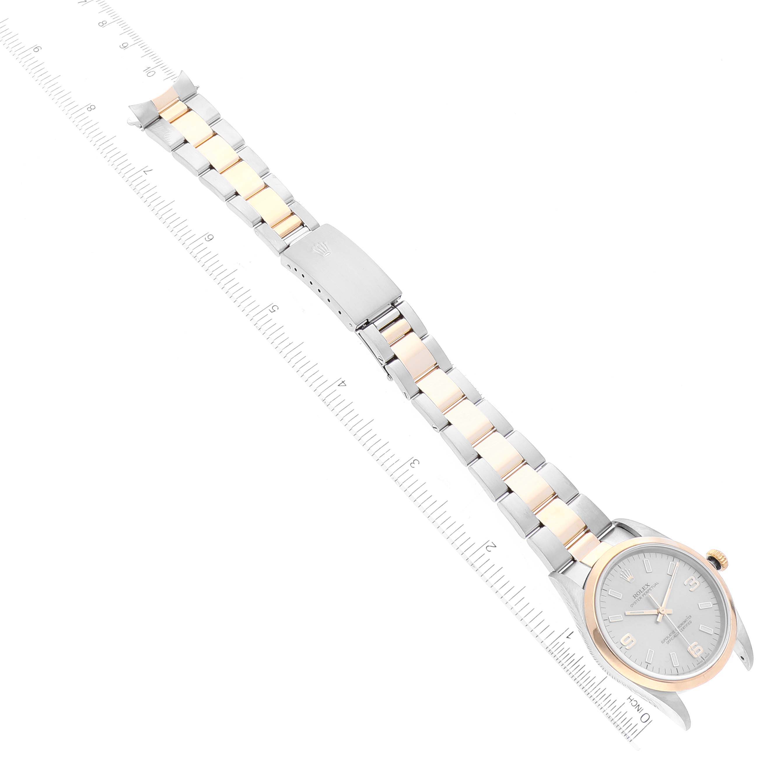 The image shows a top view of a Rolex Oyster Perpetual 14203 Men's Steel and Gold (two tone) Grey Dial 14203 Men's Steel and Gold (two tone) Grey Dial watch, including the face, bezel, and bracelet, with a ruler for scale.
