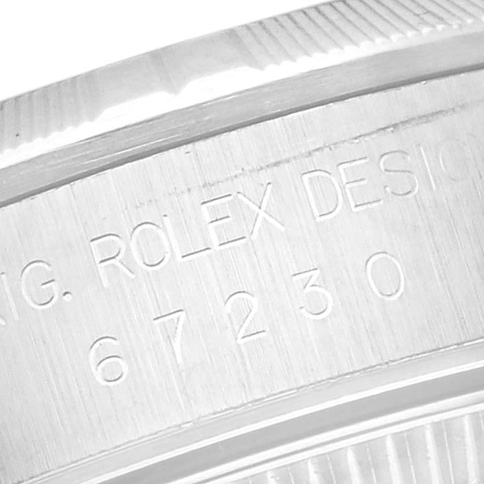 This close-up image shows part of the case side and model engraving of the Rolex Oyster Perpetual 67230 Women's Stainless Steel White Dial 67230 Women's Stainless Steel White Dial watch.