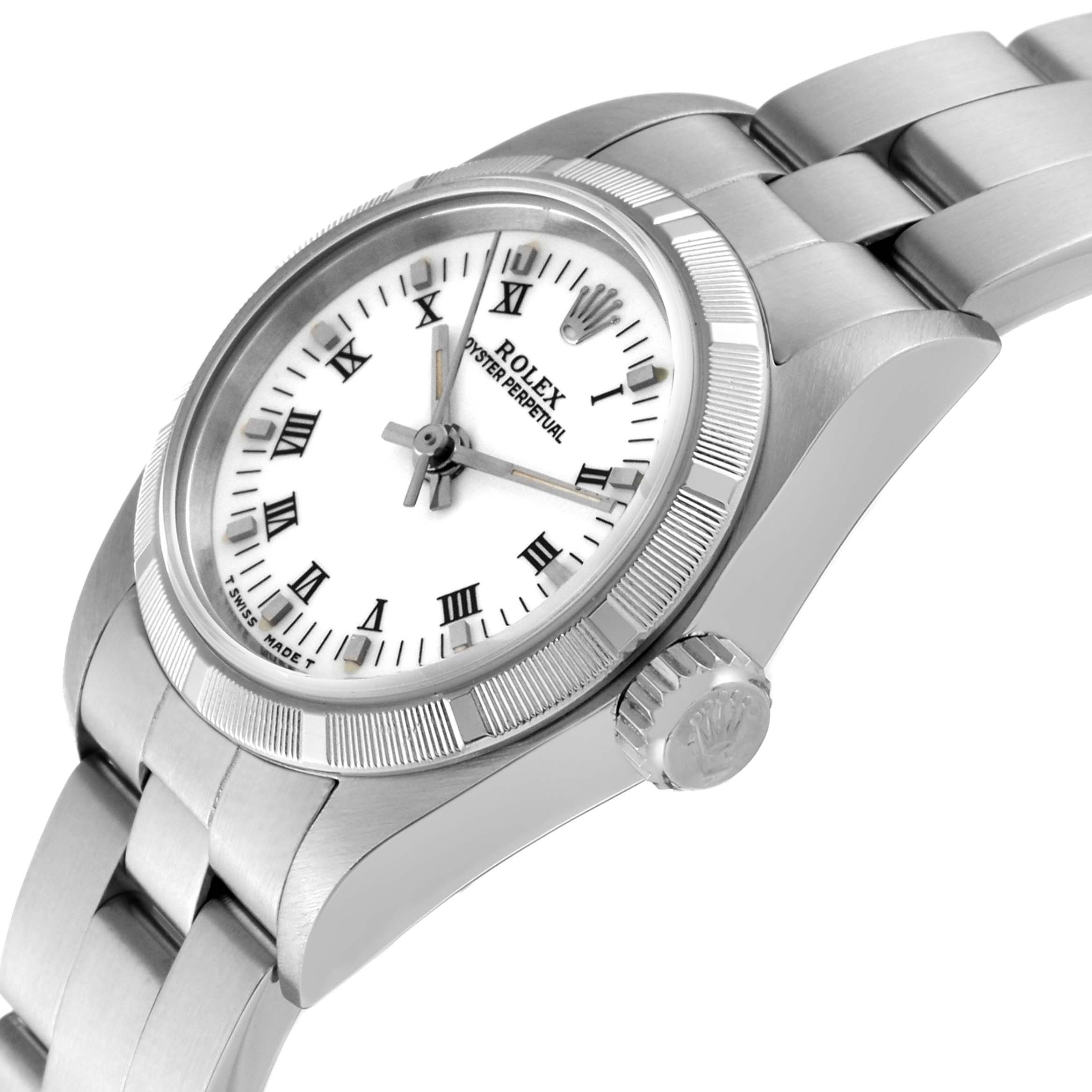 This image shows a Rolex Oyster Perpetual 67230 Women's Stainless Steel White Dial 67230 Women's Stainless Steel White Dial watch tilted slightly, highlighting its dial, crown, bezel, and a segment of the bracelet.
