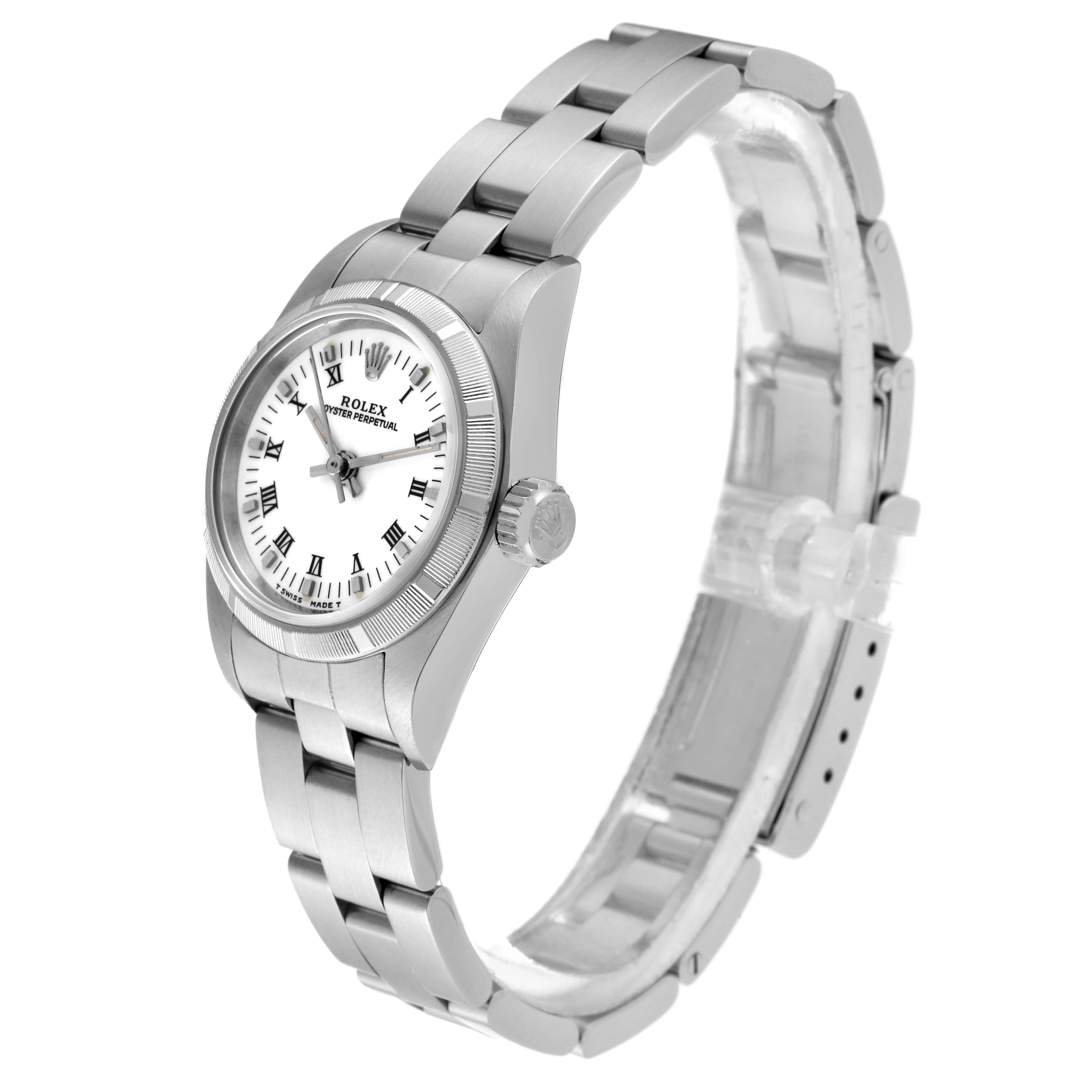 The image shows a side angle of the Rolex Oyster Perpetual 67230 Women's Stainless Steel White Dial 67230 Women's Stainless Steel White Dial watch, displaying its face, crown, and metal bracelet.