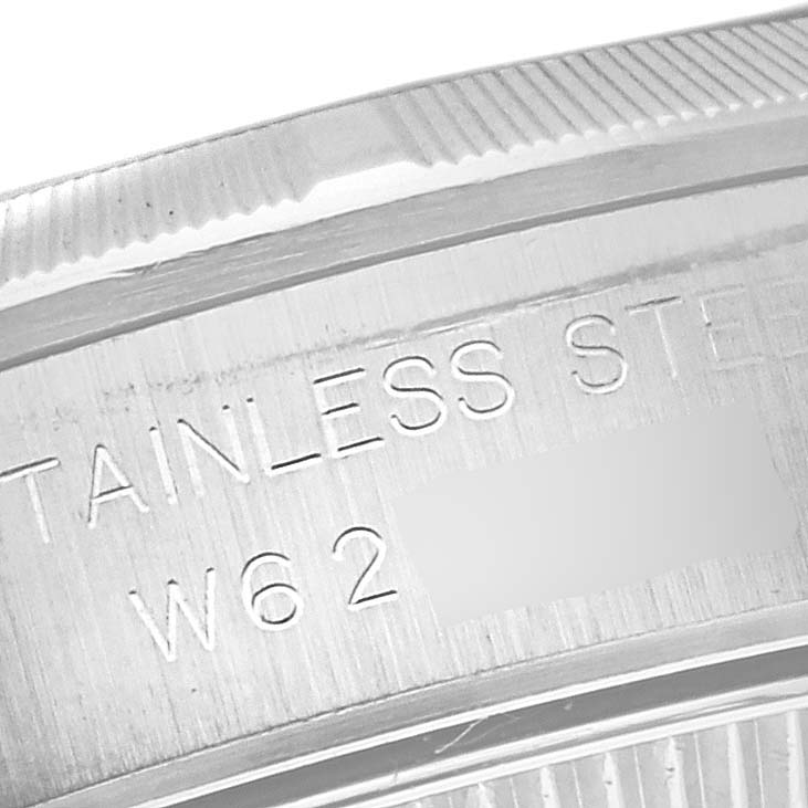 This image shows a close-up of the stainless steel case back and reference number of a Rolex Oyster Perpetual 67230 Women's Stainless Steel White Dial 67230 Women's Stainless Steel White Dial watch.