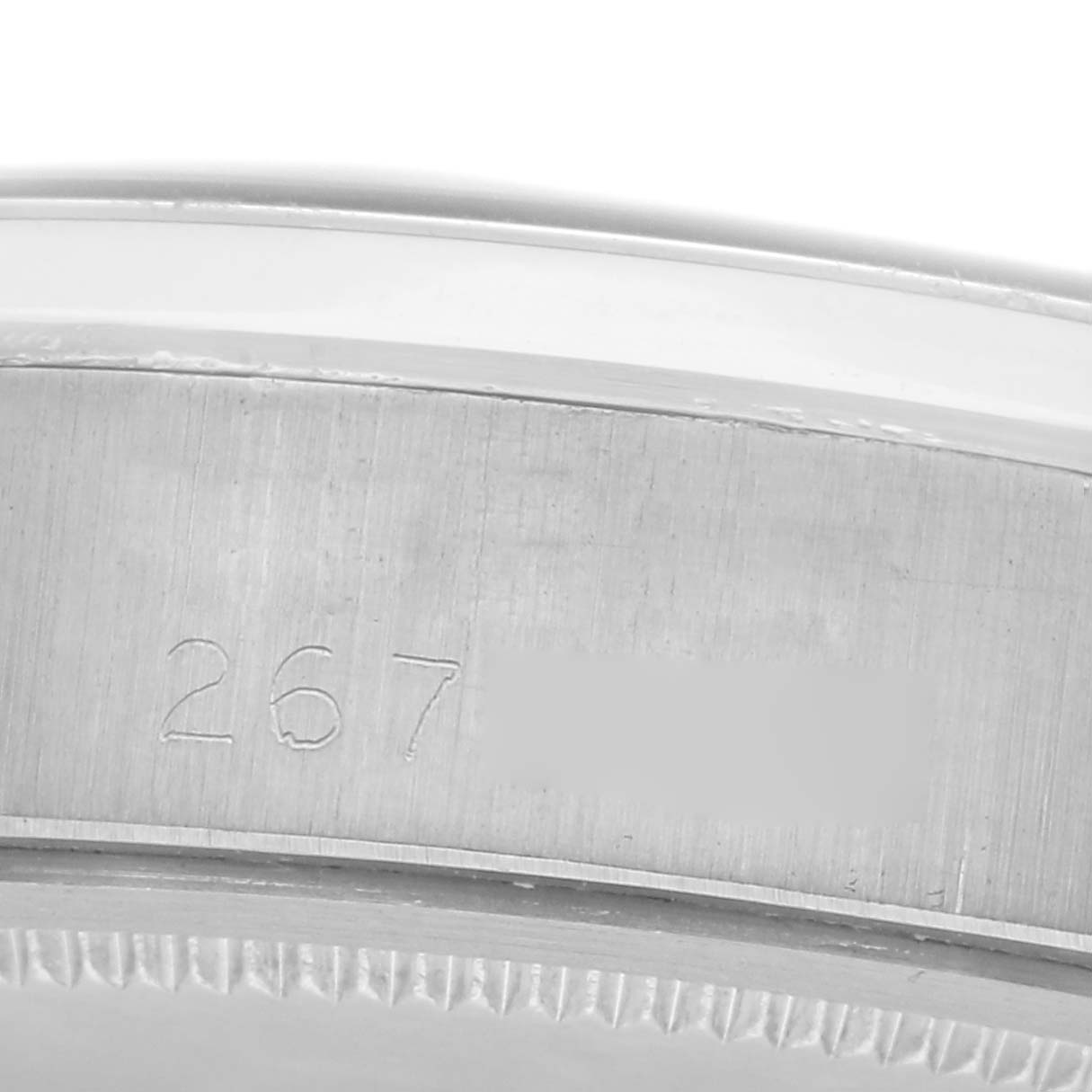 The image shows a partial view of the side casing of a Rolex Date model number 6694, focusing on the engraved serial number area.