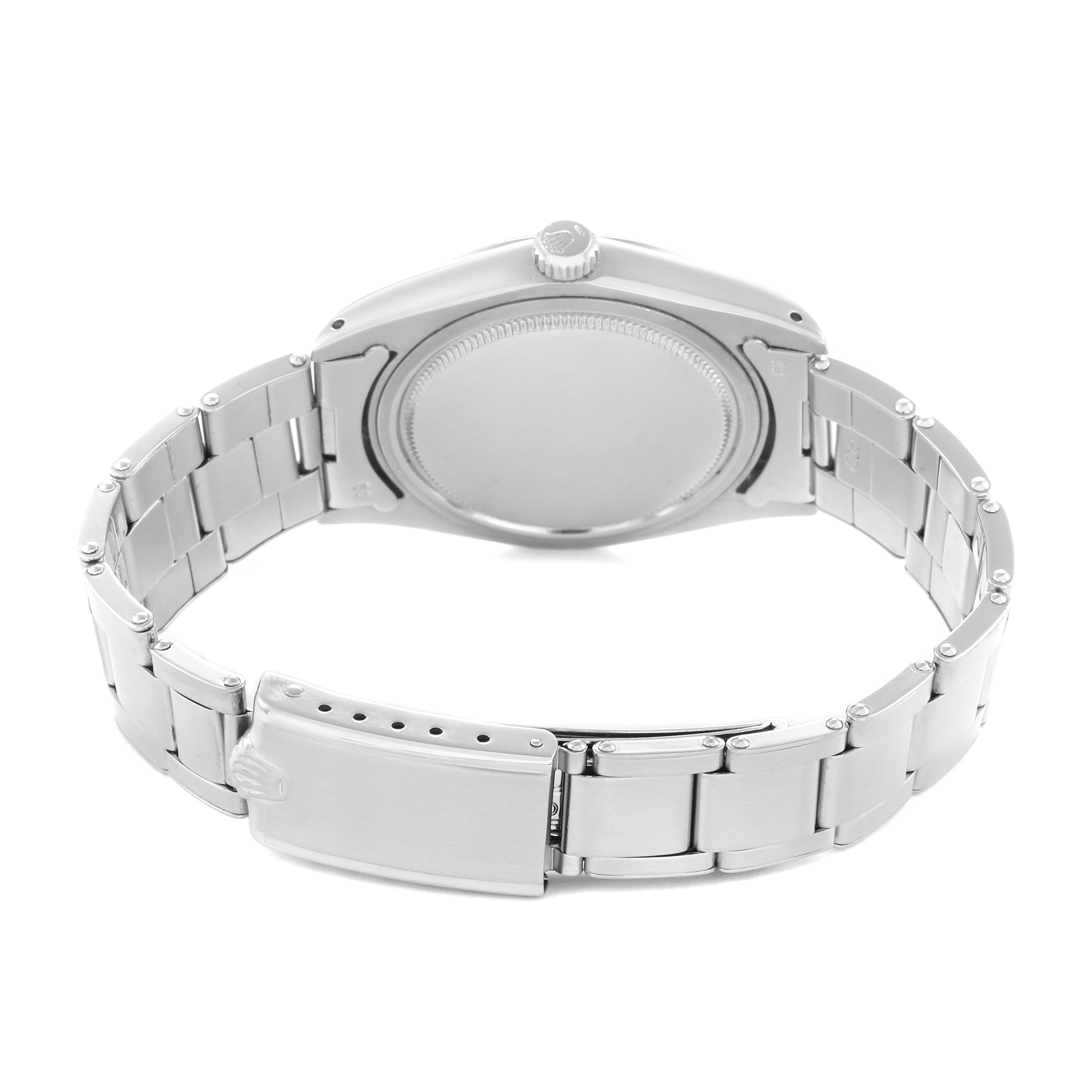 The image shows the back case and bracelet of a Rolex Date model 6694 men's watch, displayed from a rear angle focusing on the clasp and case back.