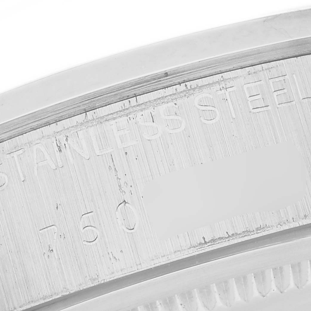 The image shows a close-up of the engraved stainless steel case back of a Vintage Collection model by Rolex.