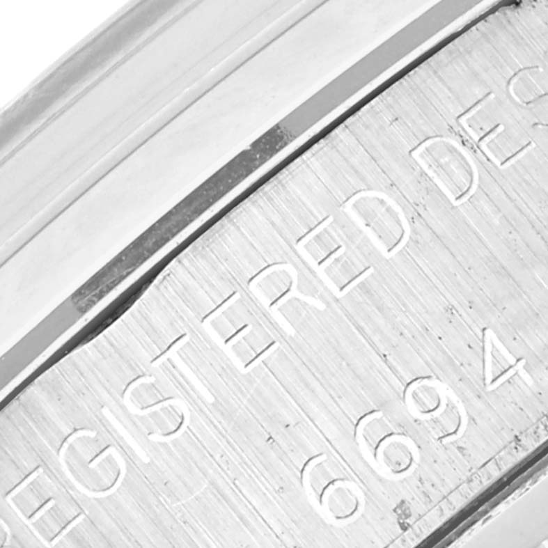 The image shows a close-up of the serial number on the case of a Rolex Vintage Collection 6694 Men's Stainless Steel Silver Dial 6694 Men's Stainless Steel Silver Dial model.