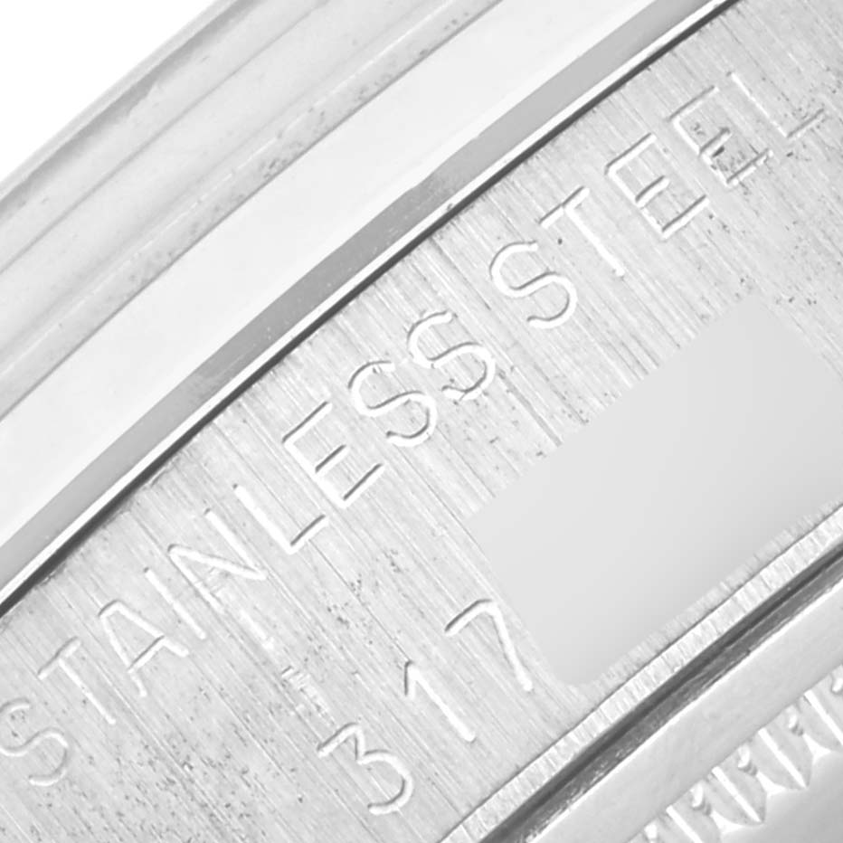 The angle shows a close-up of the Rolex Vintage Collection 6694 Men's Stainless Steel Silver Dial 6694 Men's Stainless Steel Silver Dial watch's stainless steel case engraving.