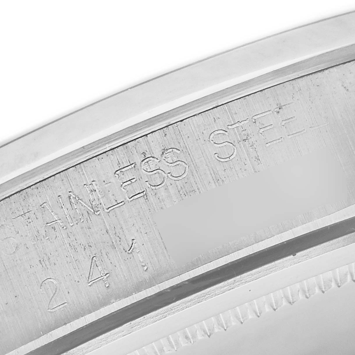 The image shows an angled close-up of the stainless steel casing engravings on a Rolex Vintage Collection 6694 Men's Stainless Steel Silver Dial 6694 Men's Stainless Steel Silver Dial model.