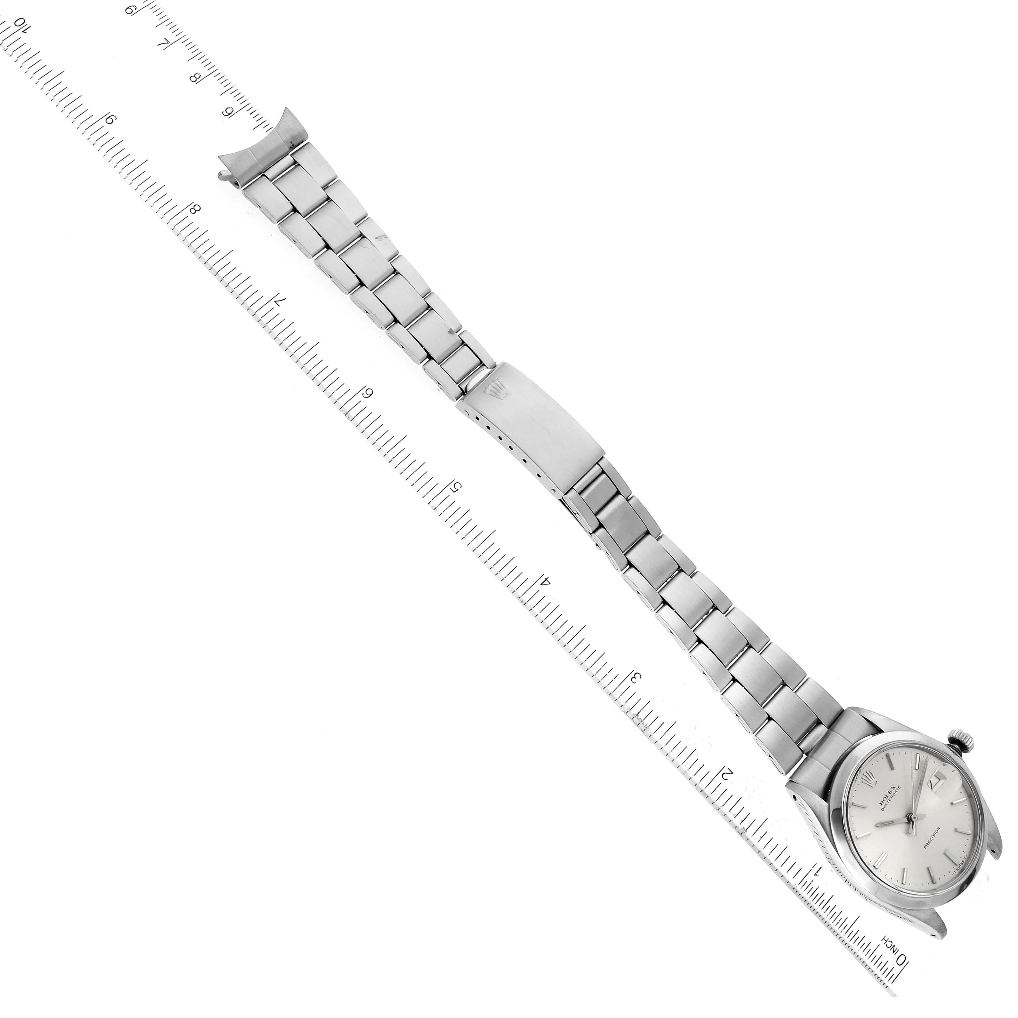 The image shows a Rolex Vintage Collection 6694 Men's Stainless Steel Silver Dial 6694 Men's Stainless Steel Silver Dial watch laid flat with its bracelet and clasp fully extended next to a ruler.