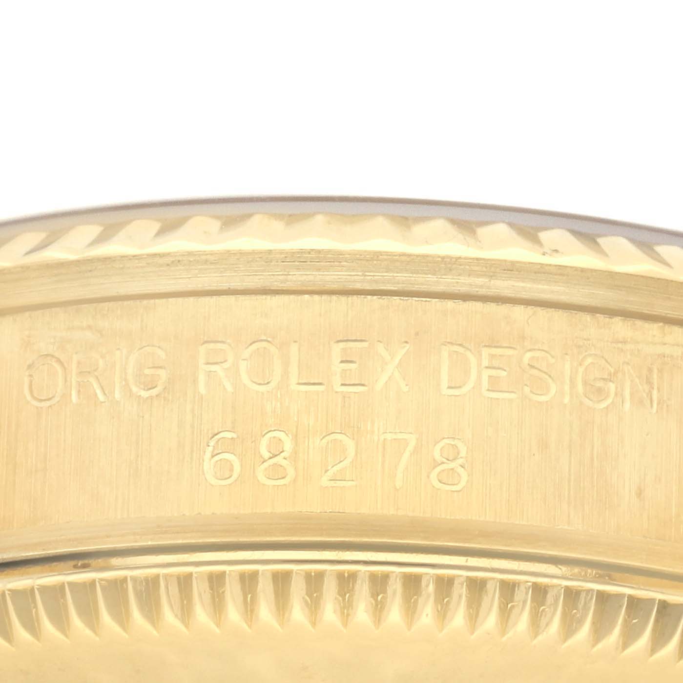 This is a close-up shot of the side of a Rolex President 68278 Women's Yellow Gold White Dial 68278 Women's Yellow Gold White Dial model, showing the reference number and design engraving.