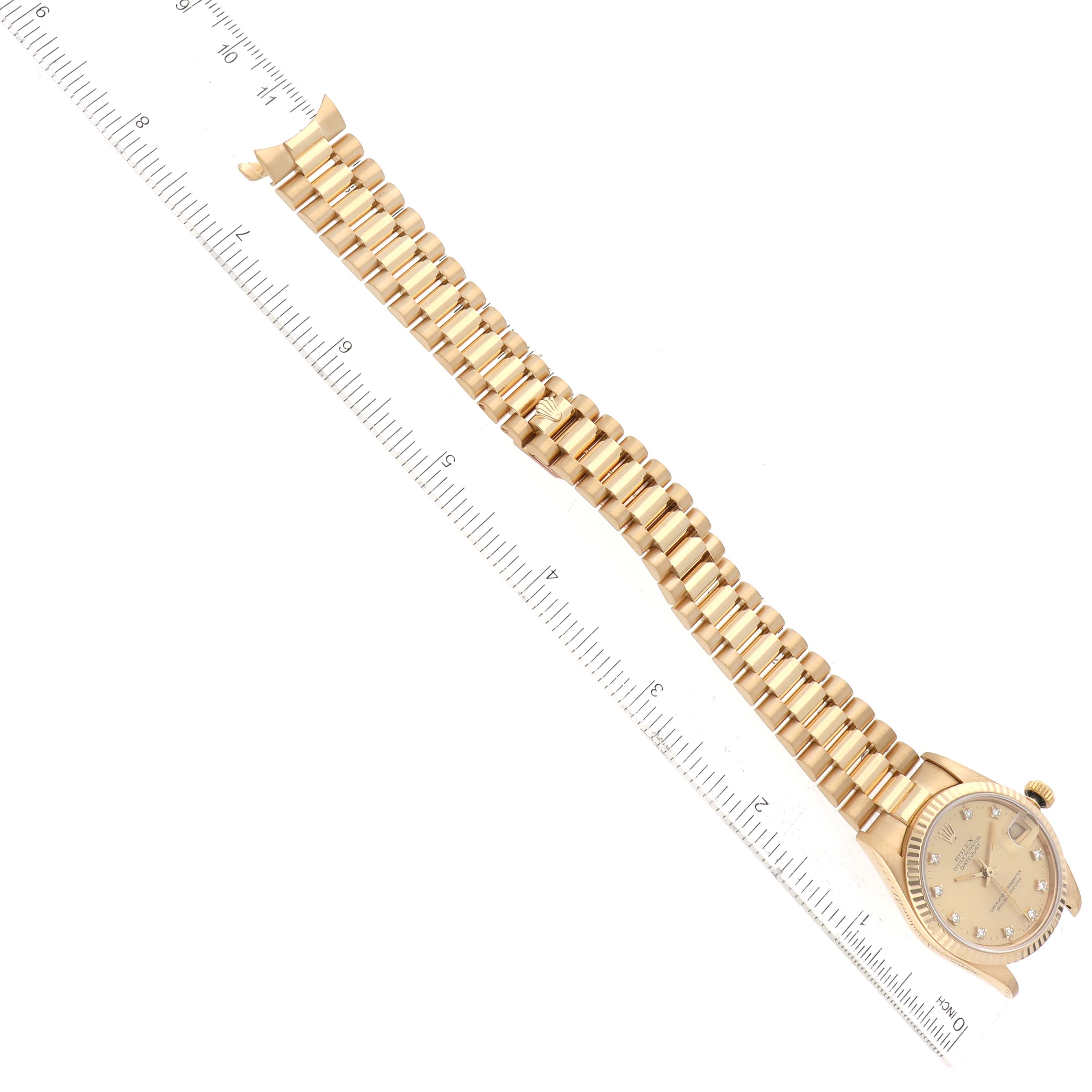 The image shows a Rolex President 68278G Women's Yellow Gold Champagne Dial 68278G Women's Yellow Gold Champagne Dial model watch, displaying the face, crown, and entire bracelet with a ruler for scale.