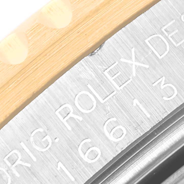 The image shows a macro shot of the engraved bezel from a Rolex Submariner 16613 Men's Steel and Gold (two tone) Blue Dial 16613 Men's Steel and Gold (two tone) Blue Dial watch.