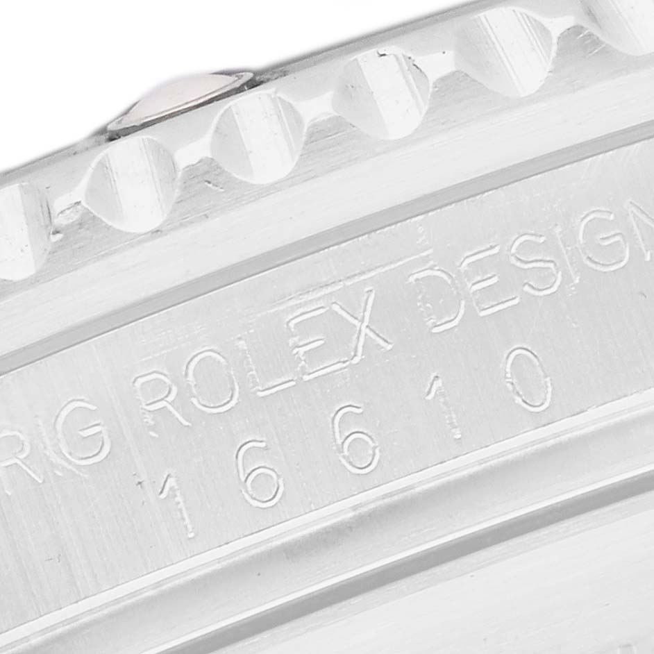 The image shows a close-up of the engraved side of a Rolex Submariner watch, model number 16610, emphasizing the text "ROLEX DESIGN" and the model number.