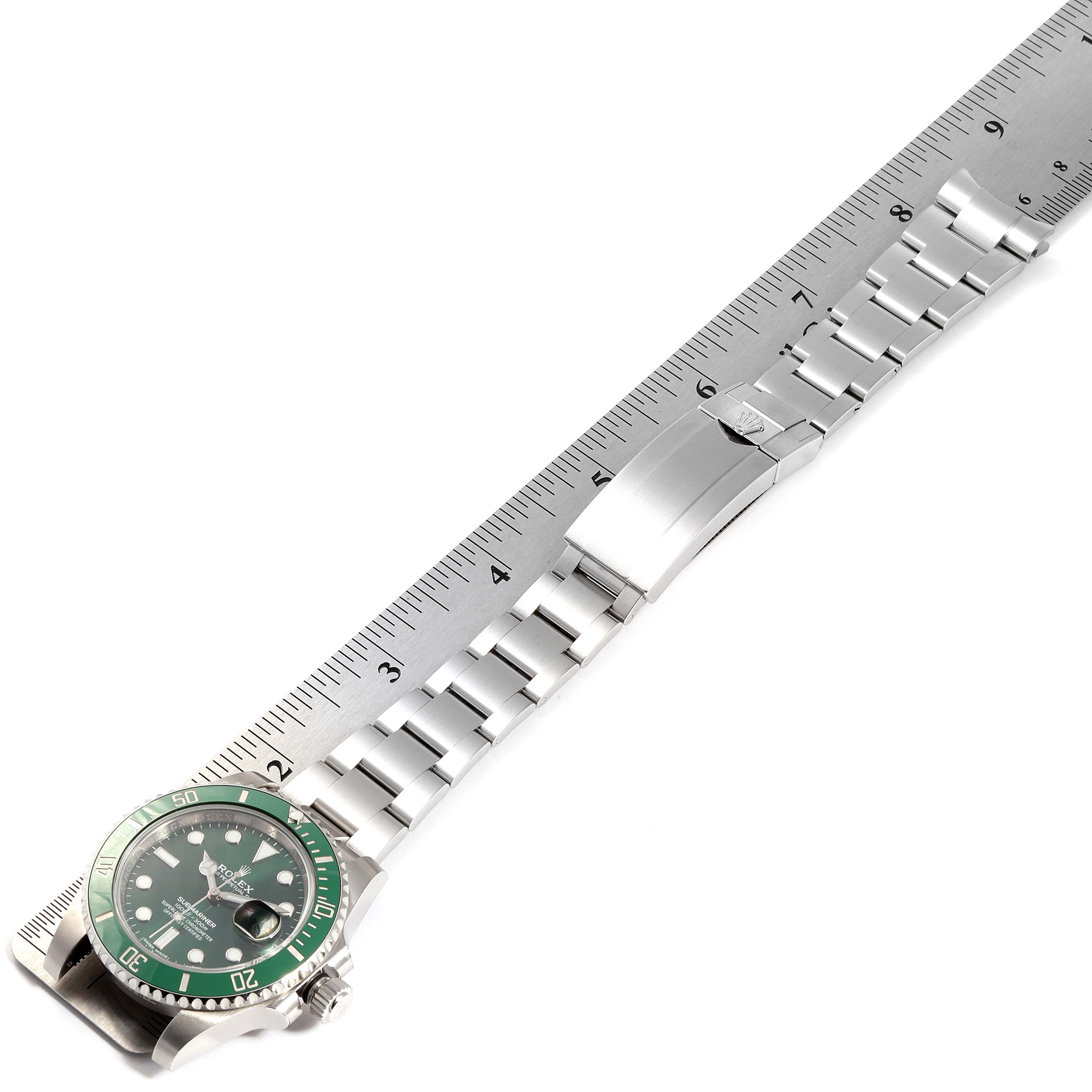 This image shows a top-down view of a Rolex Submariner 116610LV Men's Stainless Steel Green Dial 116610LV Men's Stainless Steel Green Dial watch, highlighting the dial, bezel, and bracelet next to a ruler for scale.