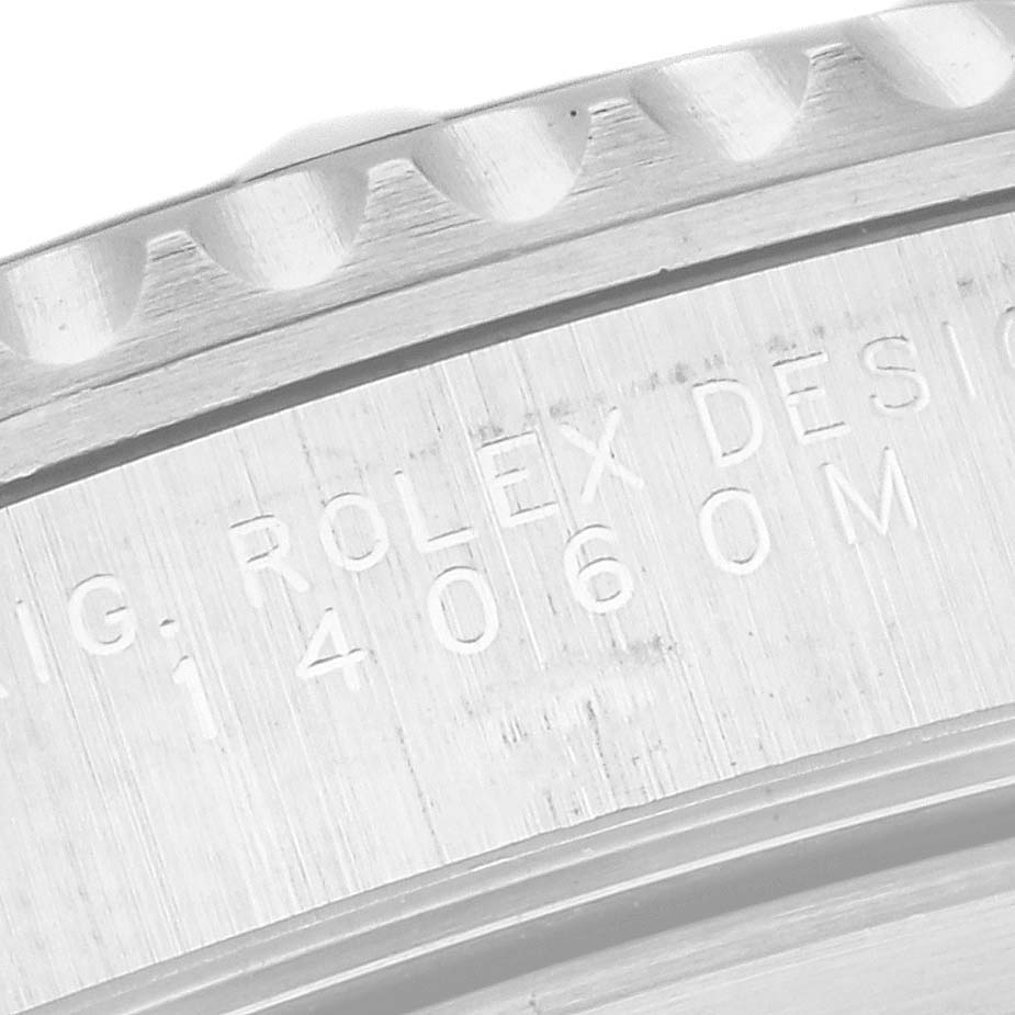 This close-up of a Rolex Submariner 14060 Men
s Stainless Steel Black Dial 14060 Men
s Stainless Steel Black Dial shows the engraved model number and part of the bezel.