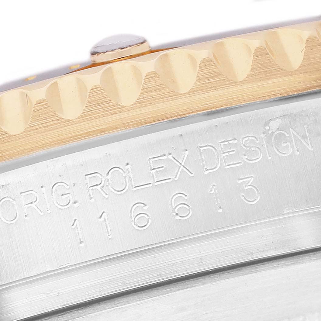 The image shows a close-up of the side of the Rolex Submariner 116613 Men's Steel and Gold (two tone) Black Dial, focusing on the engraved model number and bezel edge.