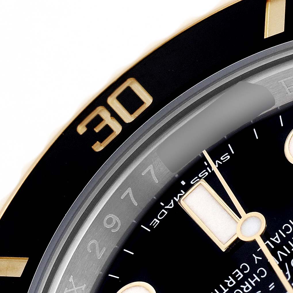 The image shows a close-up of the bezel, dial, and part of the watch face of the Rolex Submariner 116613 Men's Steel and Gold (two tone) Black Dial.