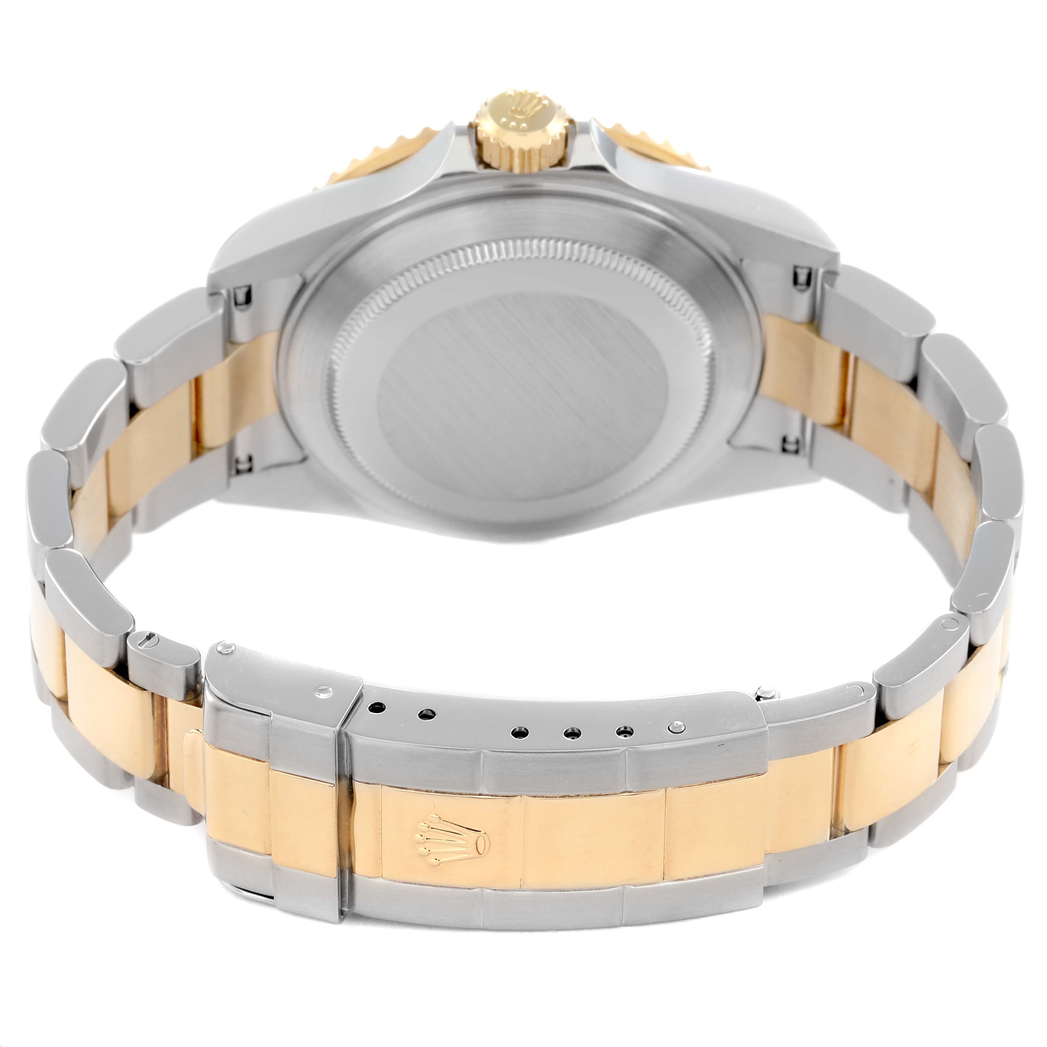 The image shows the back view of a Rolex Submariner model 16613, highlighting the clasp and bracelet, with emphasis on its two-tone metal design.