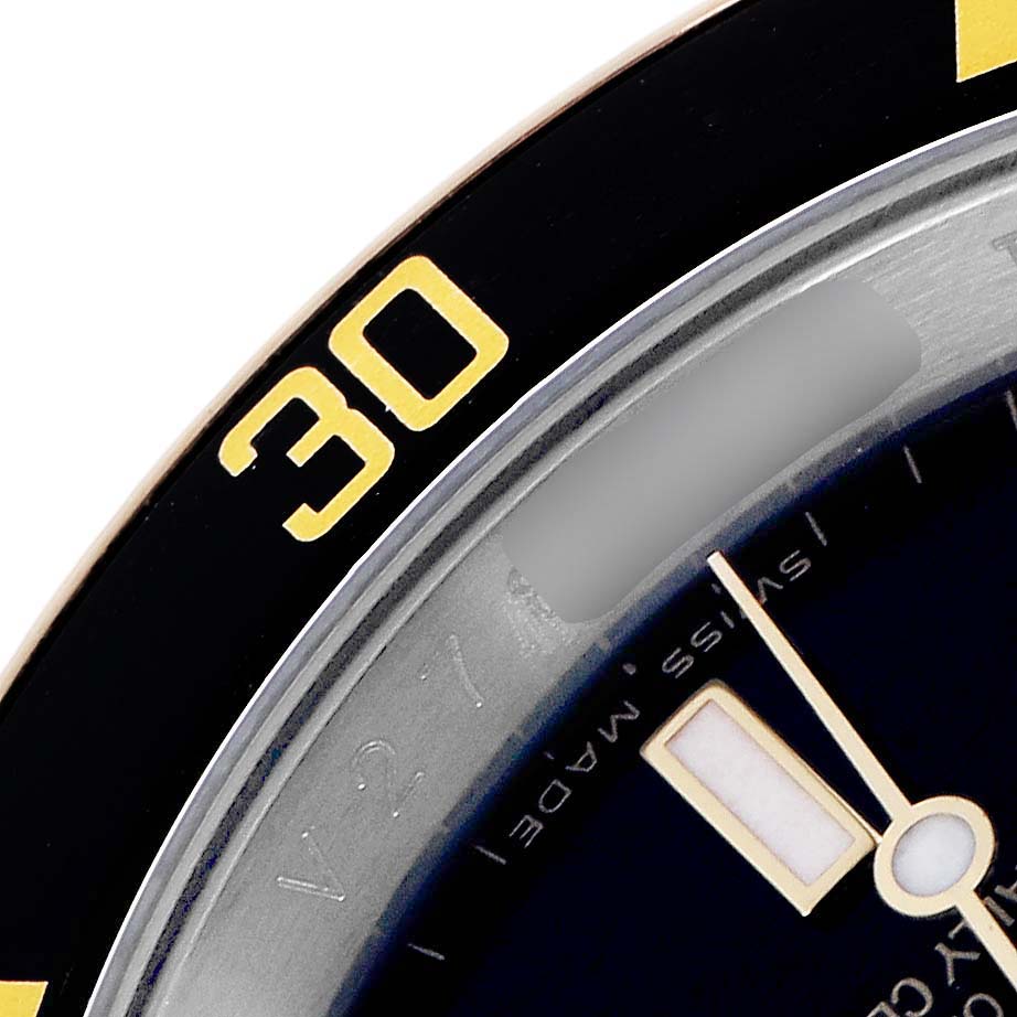 The image shows a close-up of the bezel and part of the dial on a Rolex Submariner model 16613 men's watch, with the "30" minute mark prominently displayed.