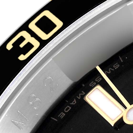 The image shows an angled close-up of the bezel and a portion of the dial and hour marker of a Rolex Submariner 16613 Men's Steel and Gold (two tone) Black Dial 16613 Men's Steel and Gold (two tone) Black Dial watch.