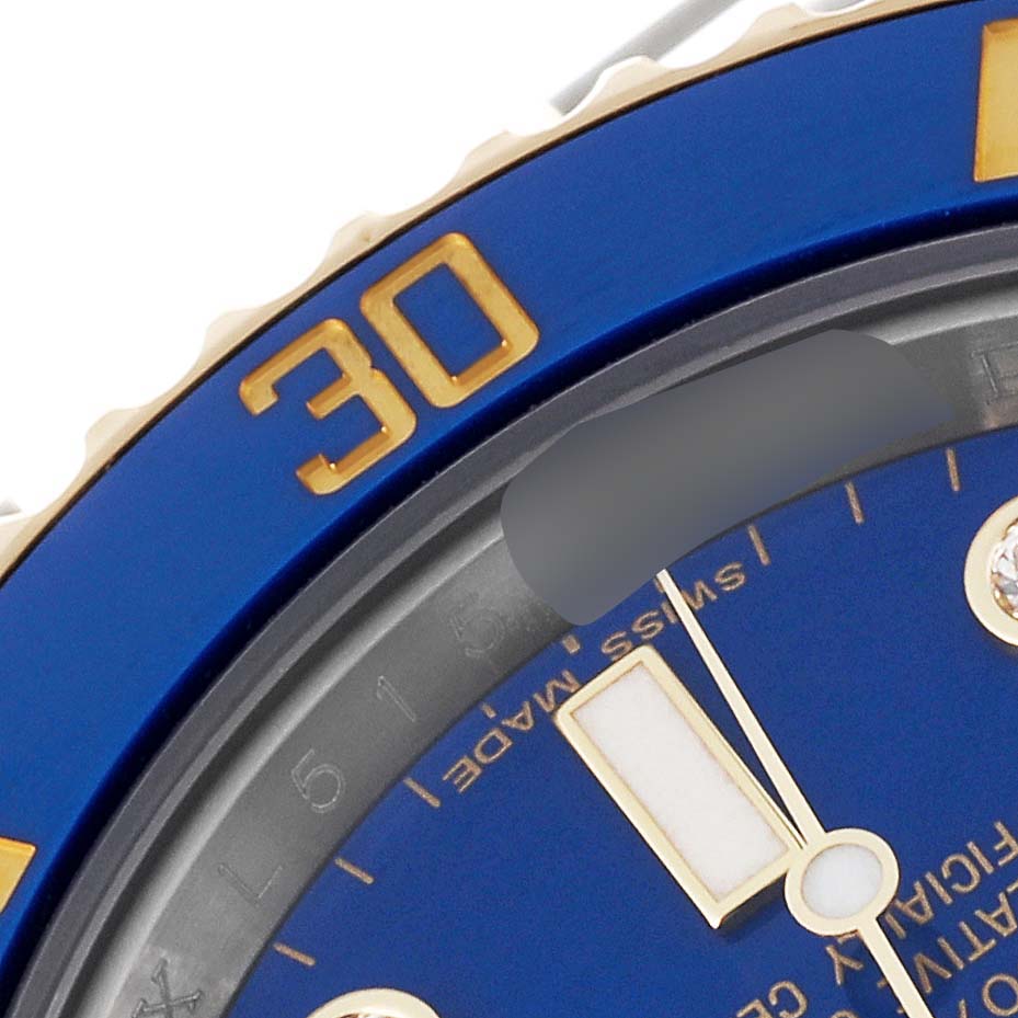 This image shows a close-up of the bezel, part of the dial, and hour markers of a Rolex Submariner 116613 Men
s Steel and Gold (two tone) Blue Dial 116613 Men
s Steel and Gold (two tone) Blue Dial watch.