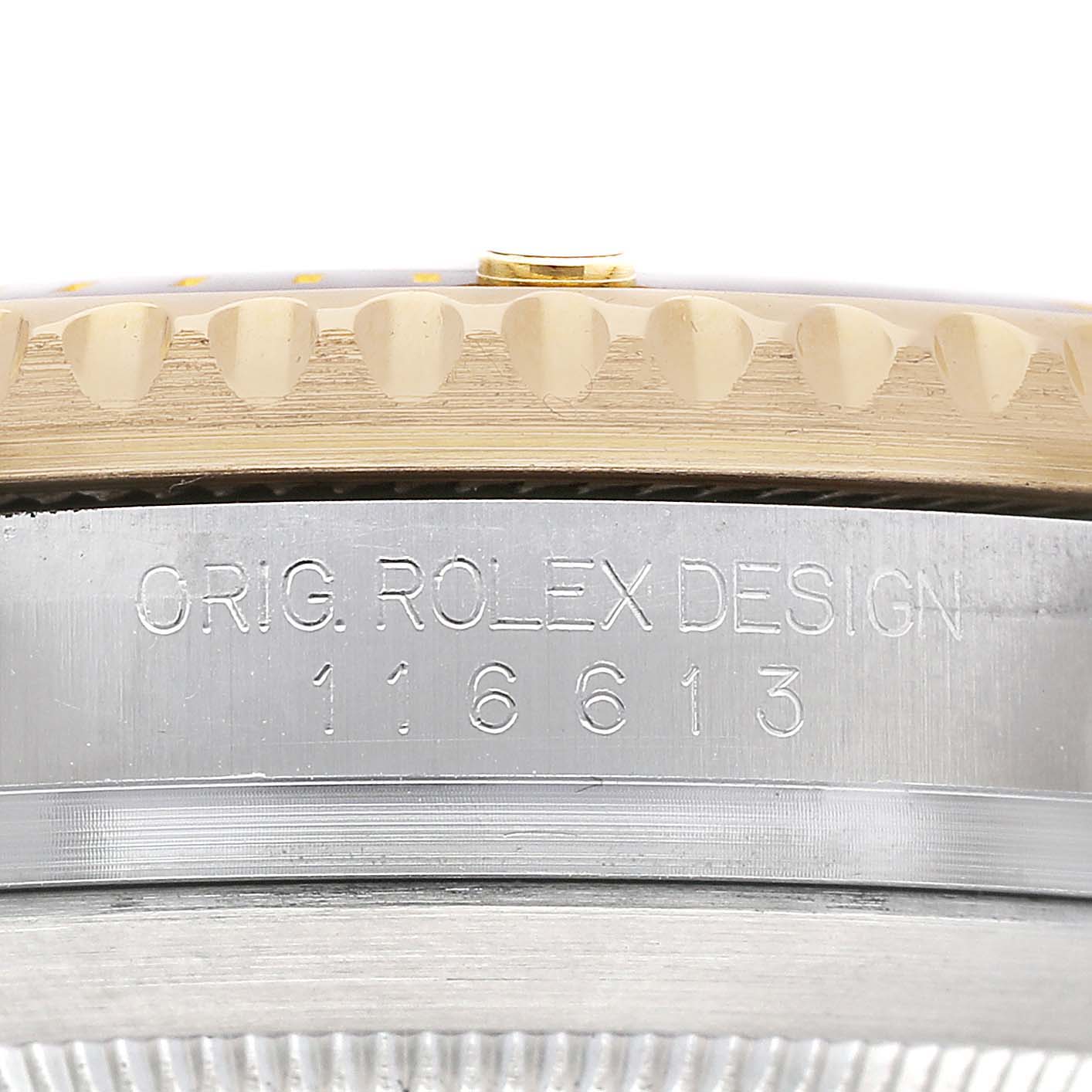 The image shows a close-up of the side of a Rolex Submariner 116613 Men's Steel and Gold (two tone) Black Dial, highlighting the engraved model number and bezel edge.