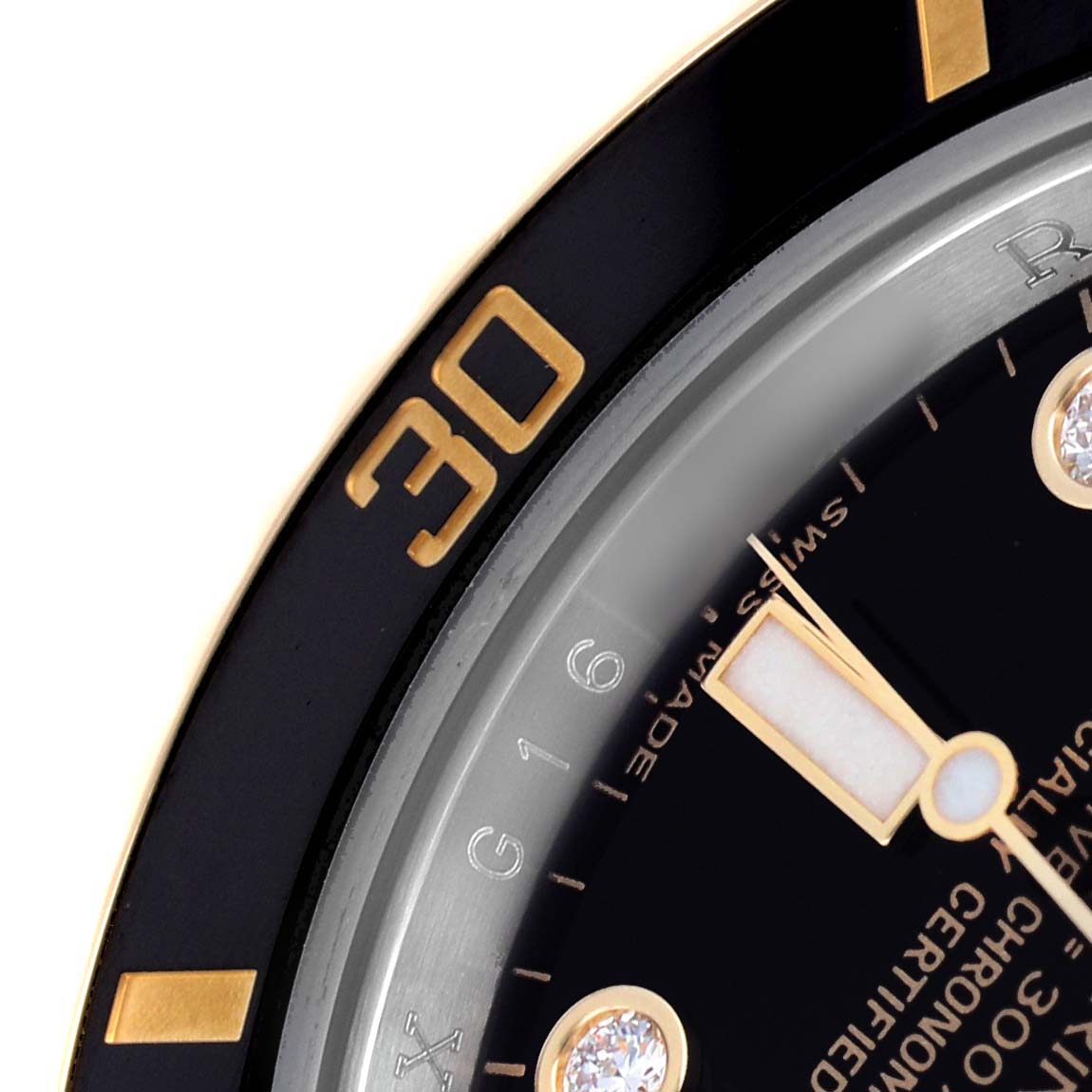 The image shows a partial close-up of the bezel, dial, and markers of a Rolex Submariner 116613 Men's Steel and Gold (two tone) Black Dial watch.