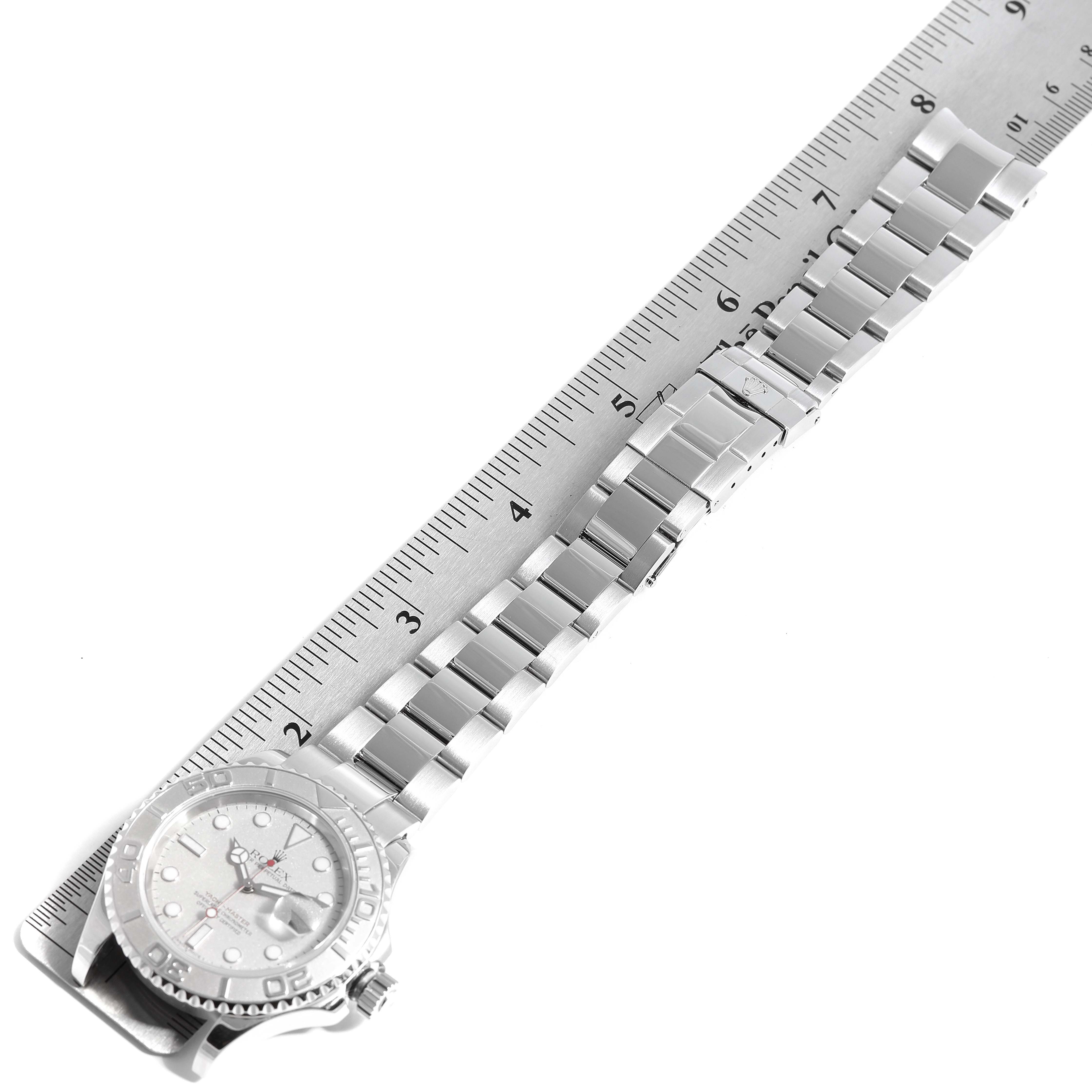 The image shows a Rolex Yacht-Master 16622 Men
s Stainless Steel Silver Dial 16622 Men
s Stainless Steel Silver Dial watch laid flat, with its bracelet extended next to a ruler for measurement.