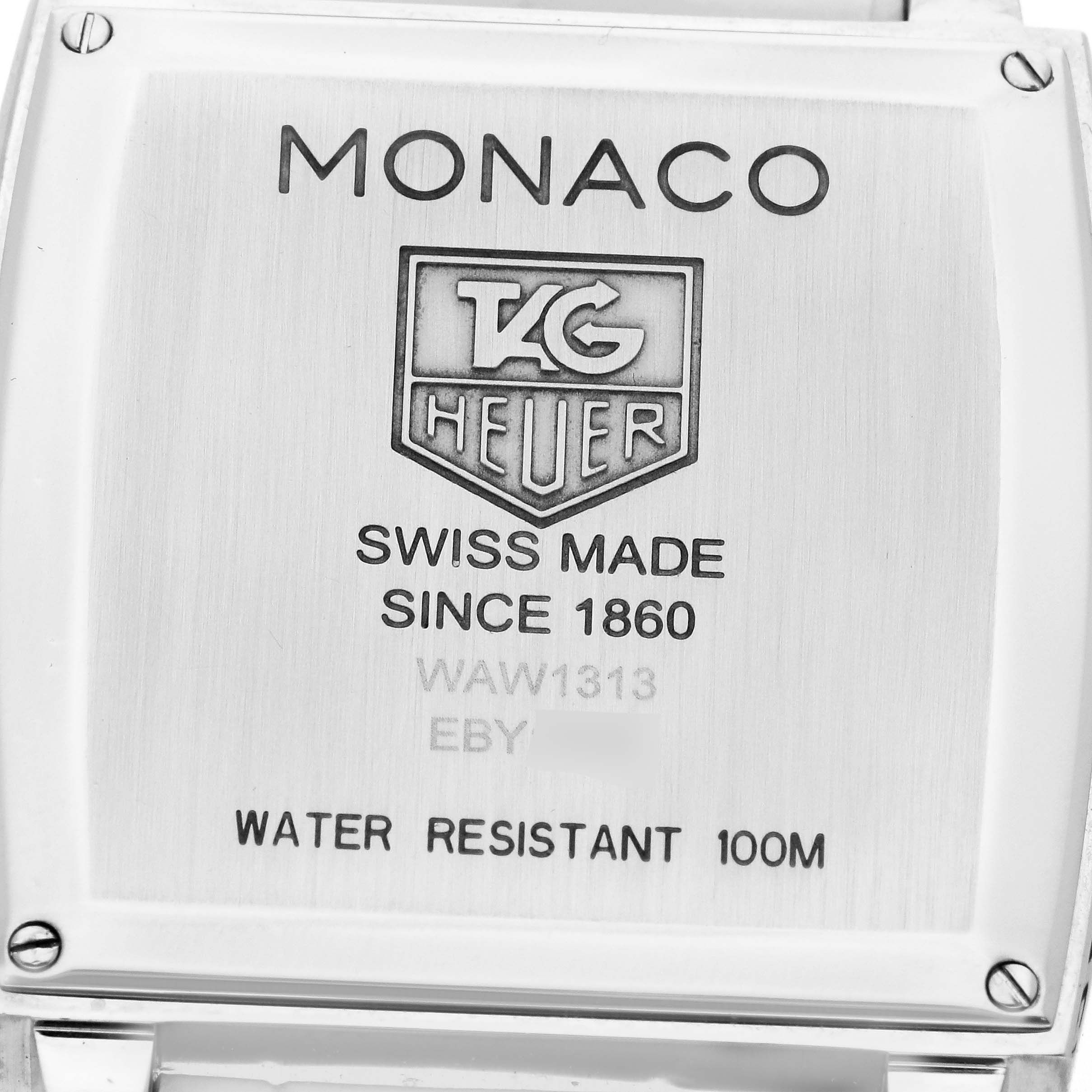 The image shows the back case of the Tag Heuer Monaco model WAW1313.FC6247, highlighting its water resistance and "Swiss Made" engravings.