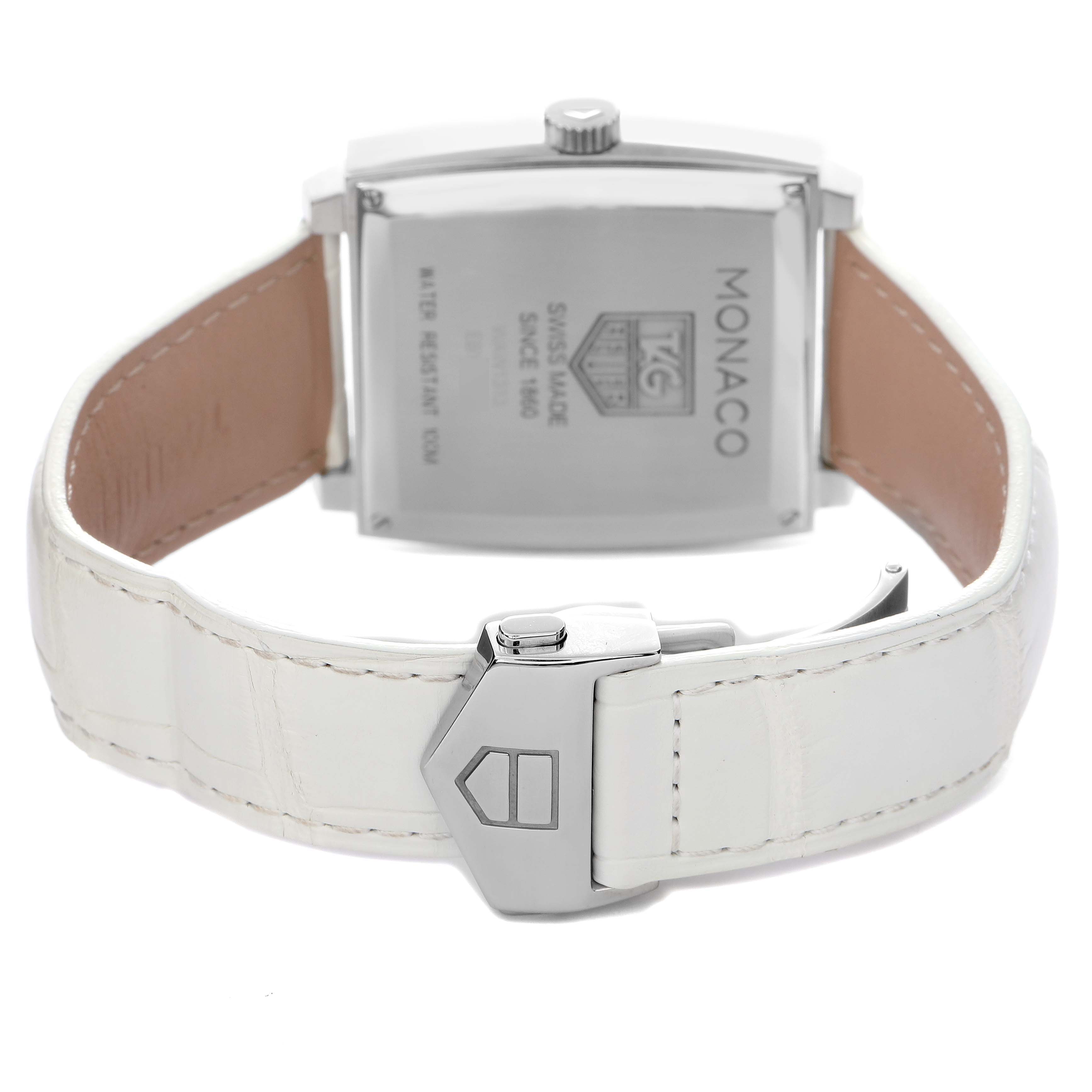 The image shows the back view of the Tag Heuer Monaco model WAW1313.FC6247, highlighting the case back and deployment clasp of the white leather strap.