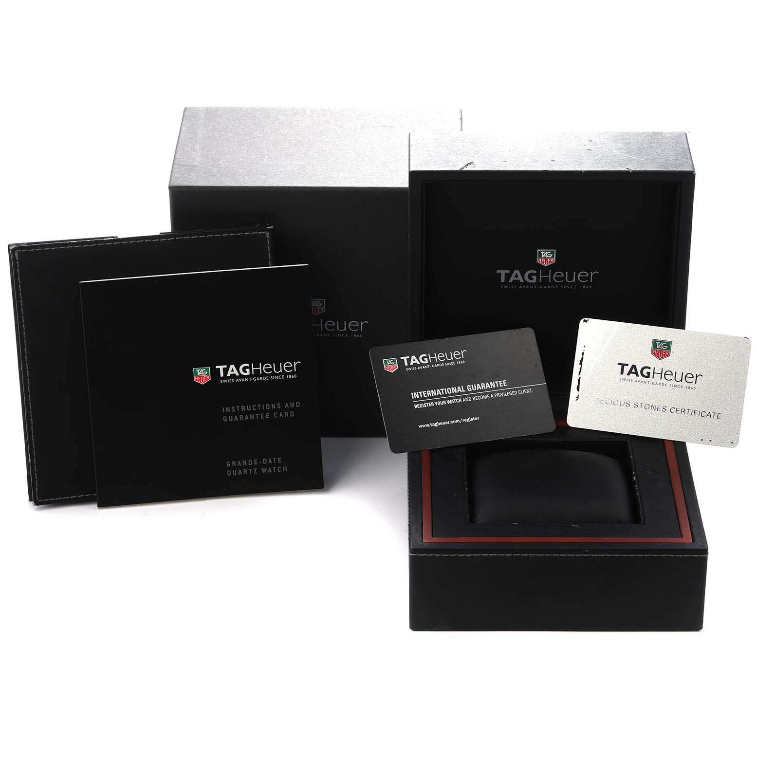 The image shows packaging and accessories for a Tag Heuer Monaco WAW1313.FC6247 watch, including the box, manuals, and guarantee cards, from a frontal angle.