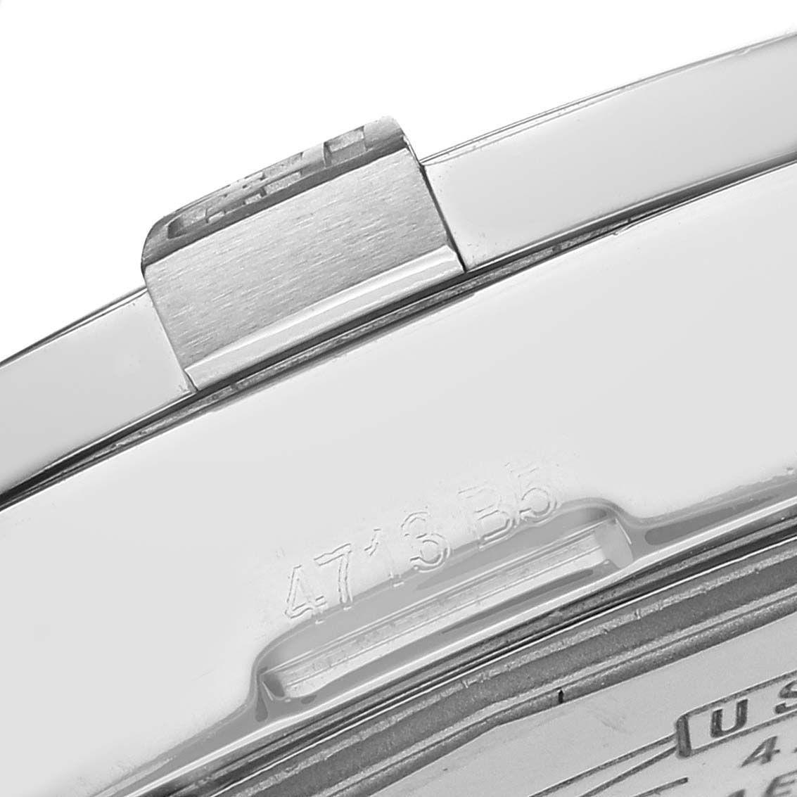 The image shows the edge of a Breitling Avenger model A32390 watch, focusing on the clasp and a portion of the engraved back.