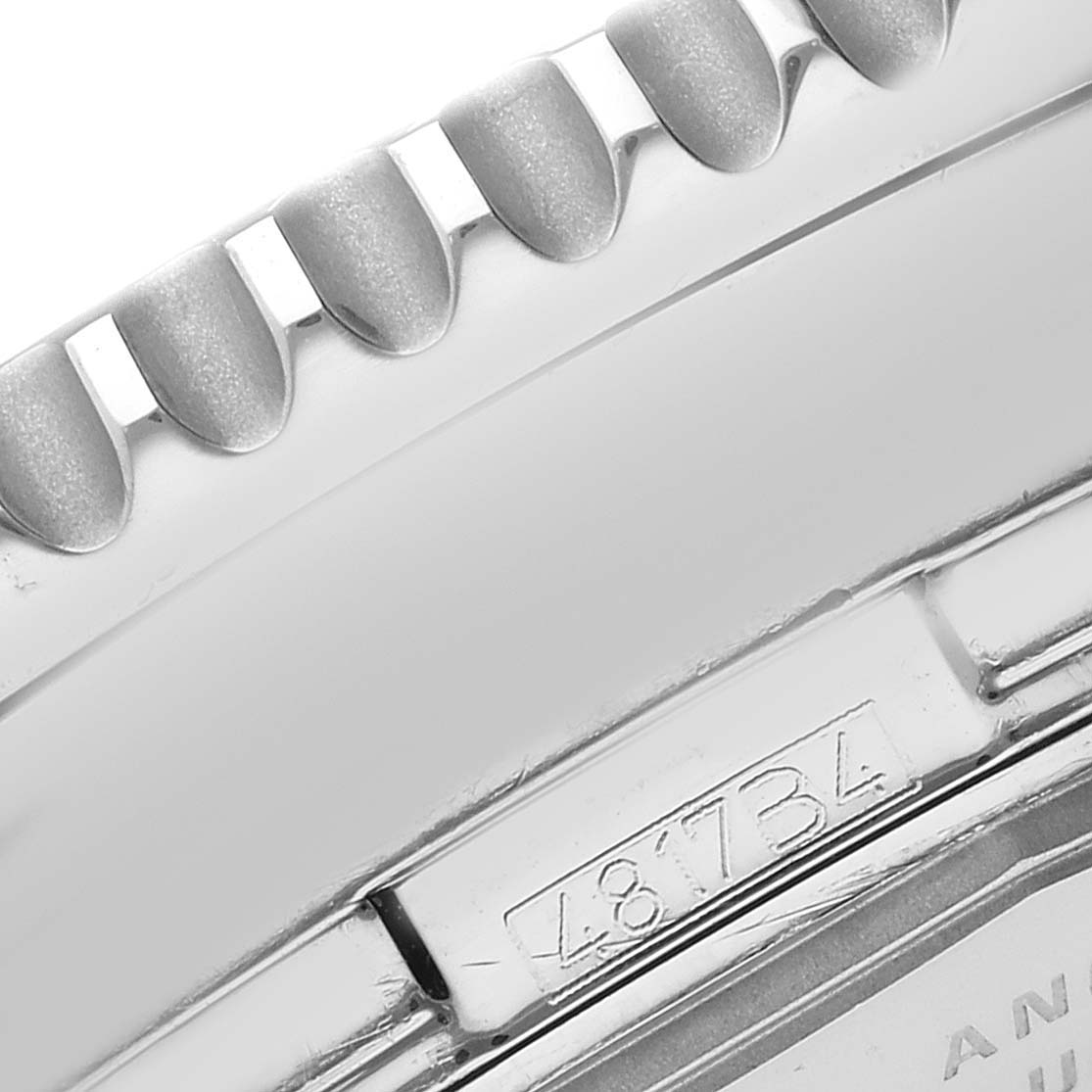 The image shows a close-up side view of the bezel and case of a Breitling Navitimer A24322 men's watch, highlighting its textured edge and serial number.