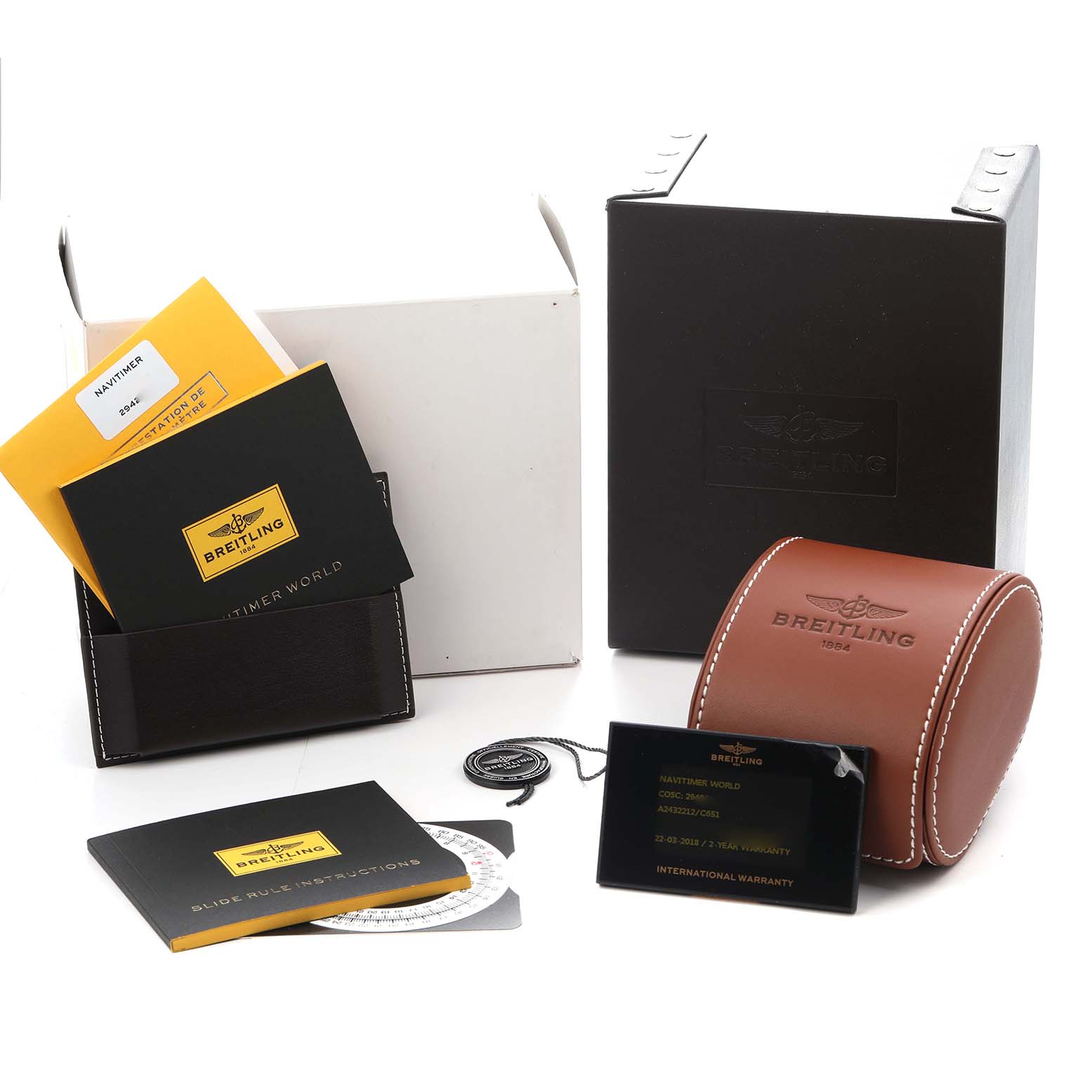 The image shows Breitling Navitimer model A24322 watch accessories, including boxes, manuals, a warranty card, and a watch case.
