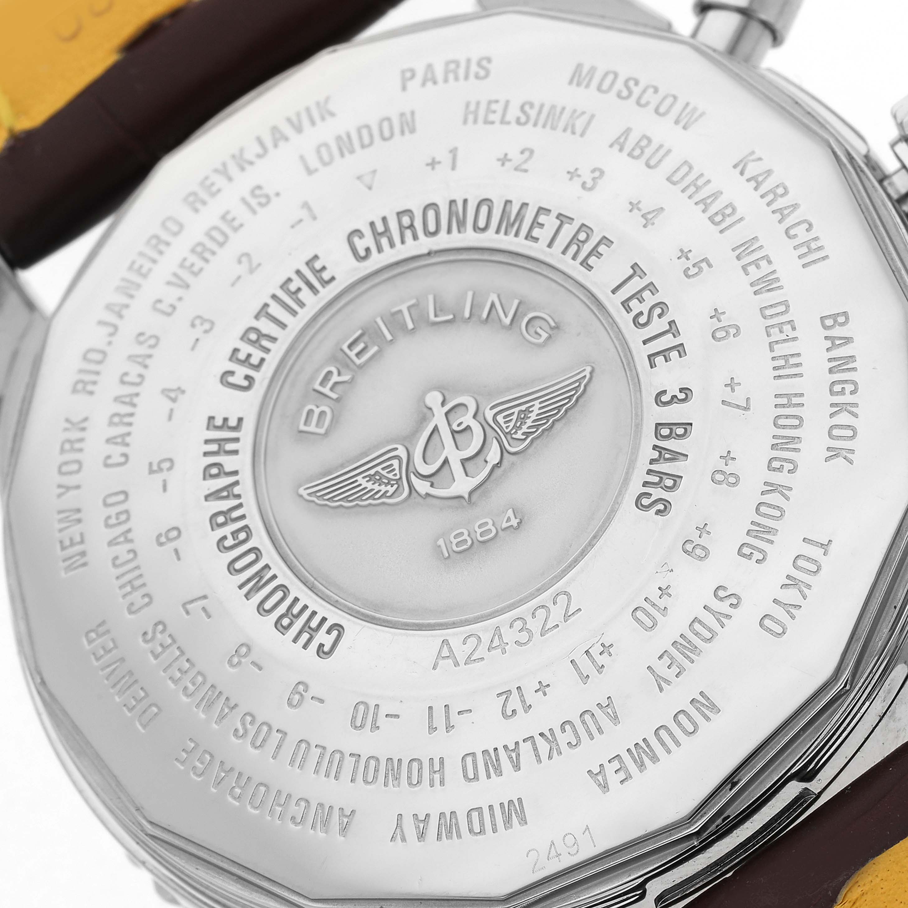 The image shows the case back of the Breitling Navitimer model A24322, displaying city names and the Breitling logo.