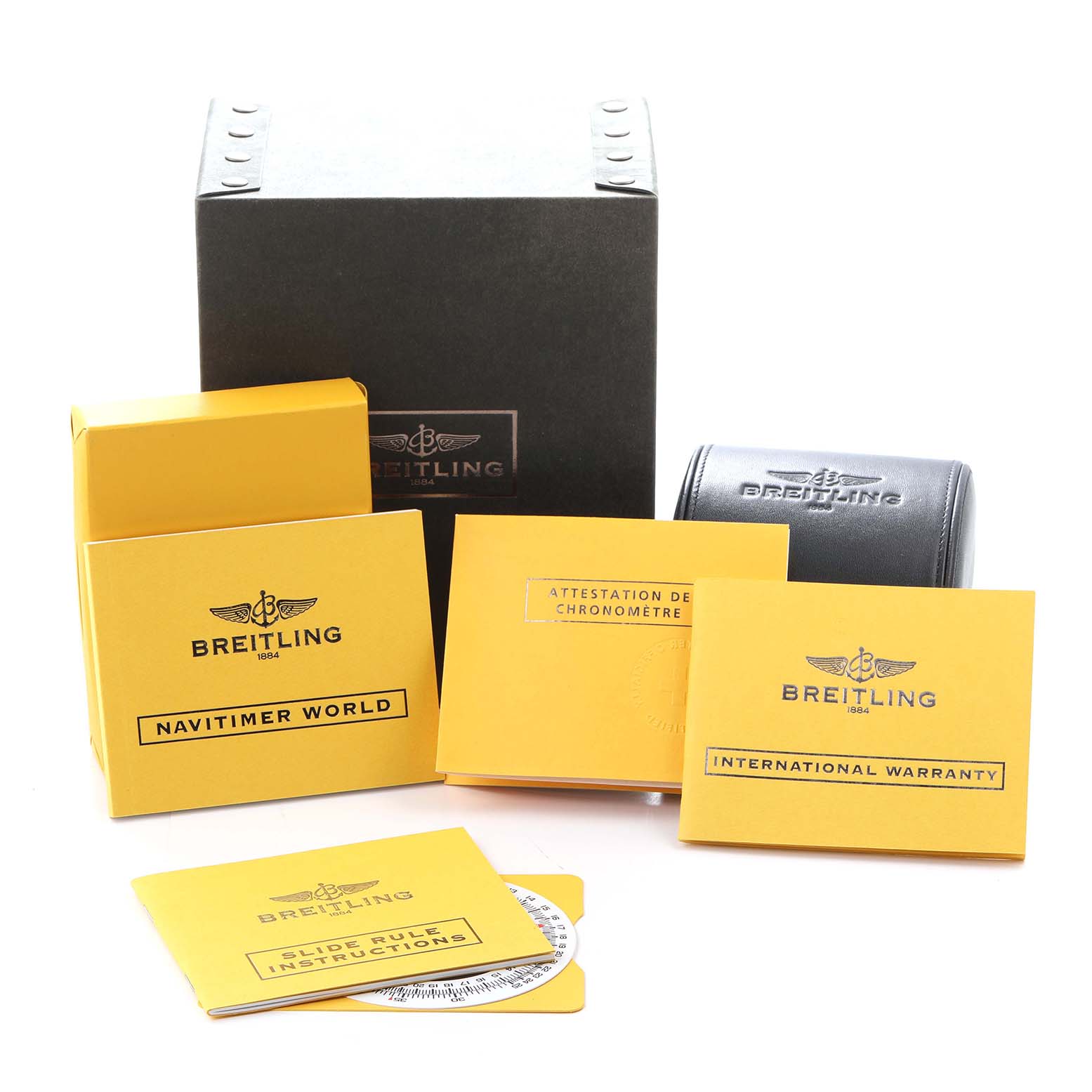 The image shows accessories for a Breitling Navitimer model A24322, including several documents, a box, and a protective case.