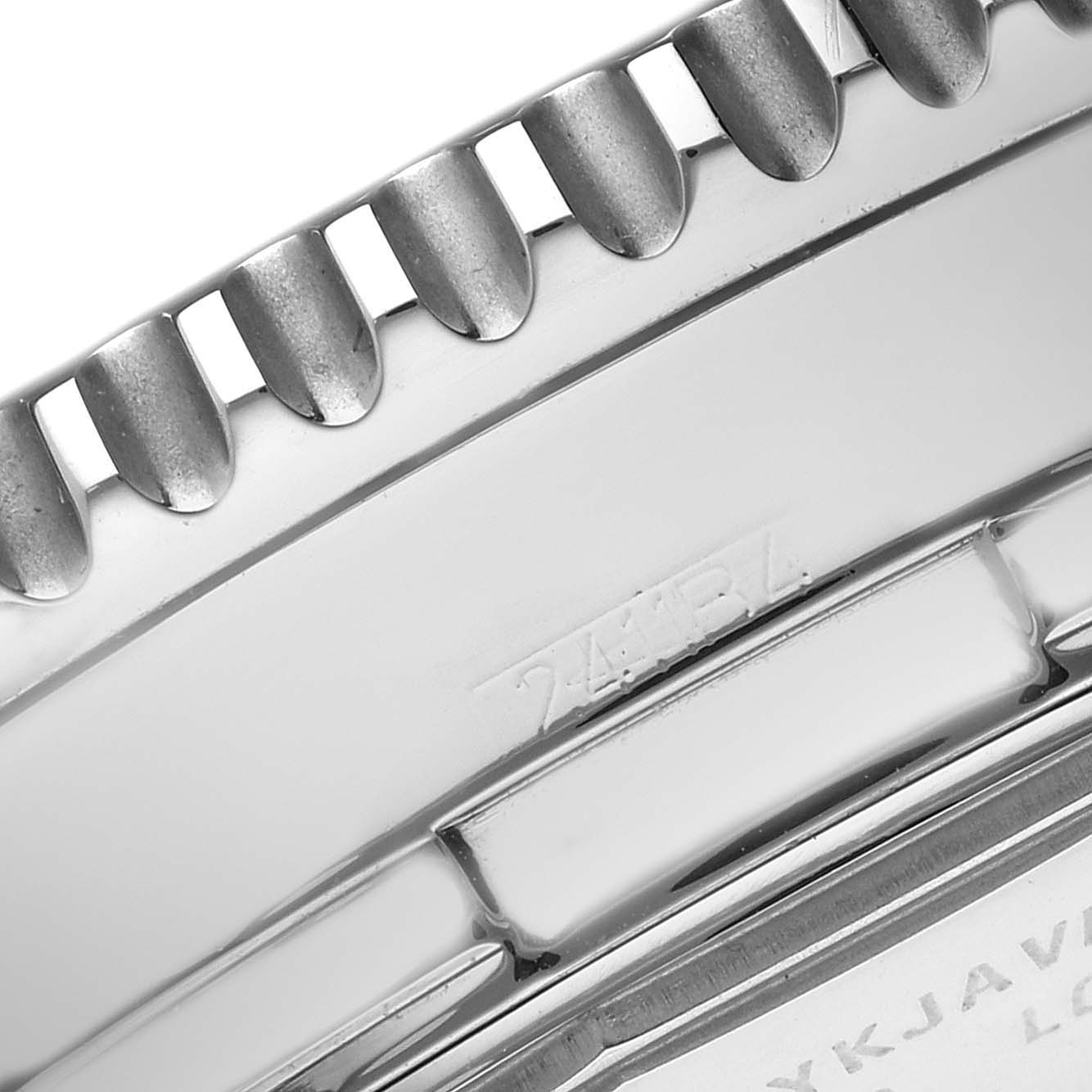The image shows a close-up of the Breitling Navitimer A24322 watch's metal bezel teeth and part of the engraved case back.