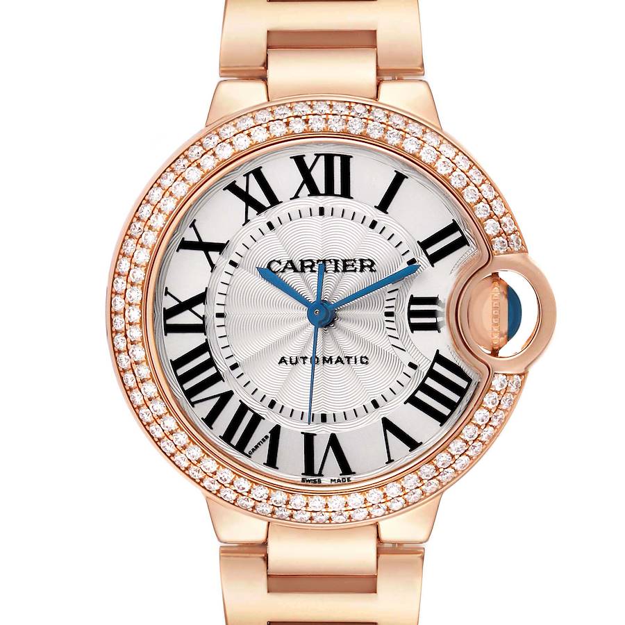 The Cartier Ballon Bleu WE902034 Women's Rose Gold Silver Dial watch is shown from the front, displaying its face, Roman numerals, blue hands, and diamond-set bezel.