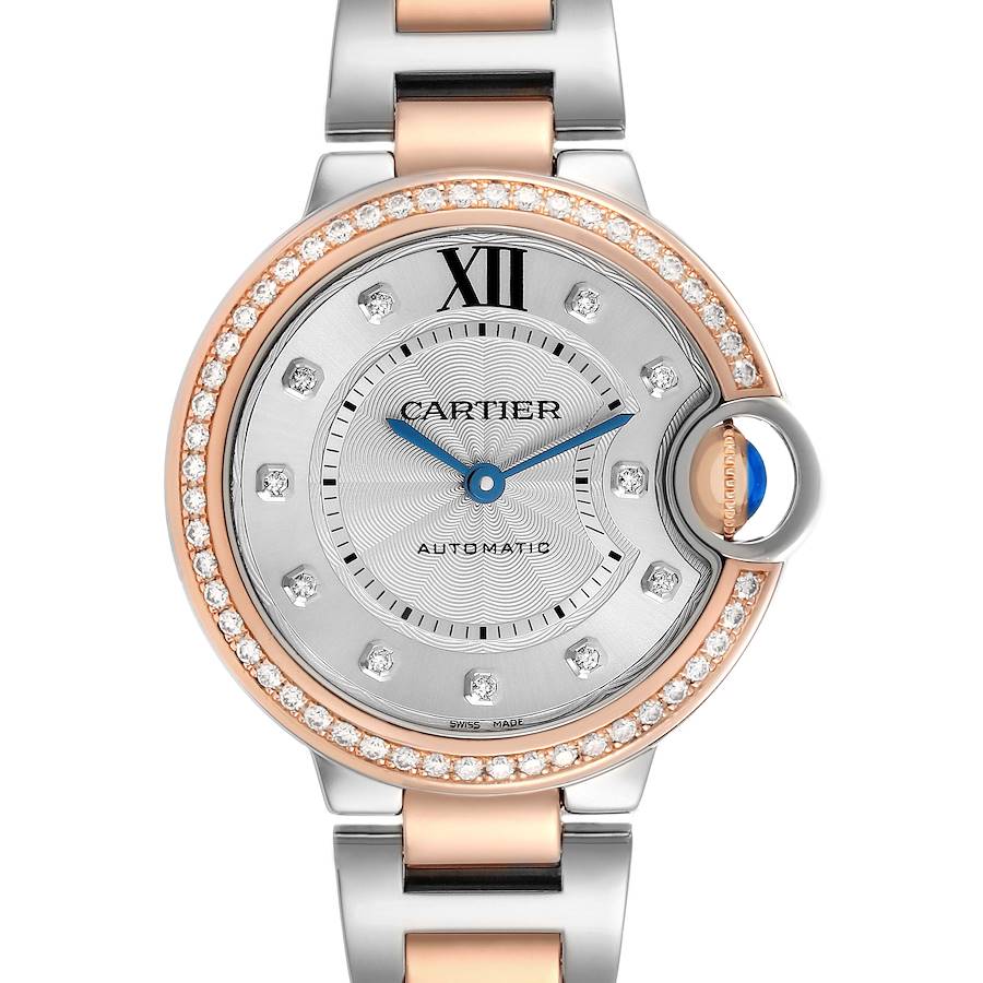 The Cartier Ballon Bleu WE902077 Women's Steel and Gold (two tone) Silver Dial watch is shown from the front, highlighting the diamond-studded bezel and blue sapphire crown.