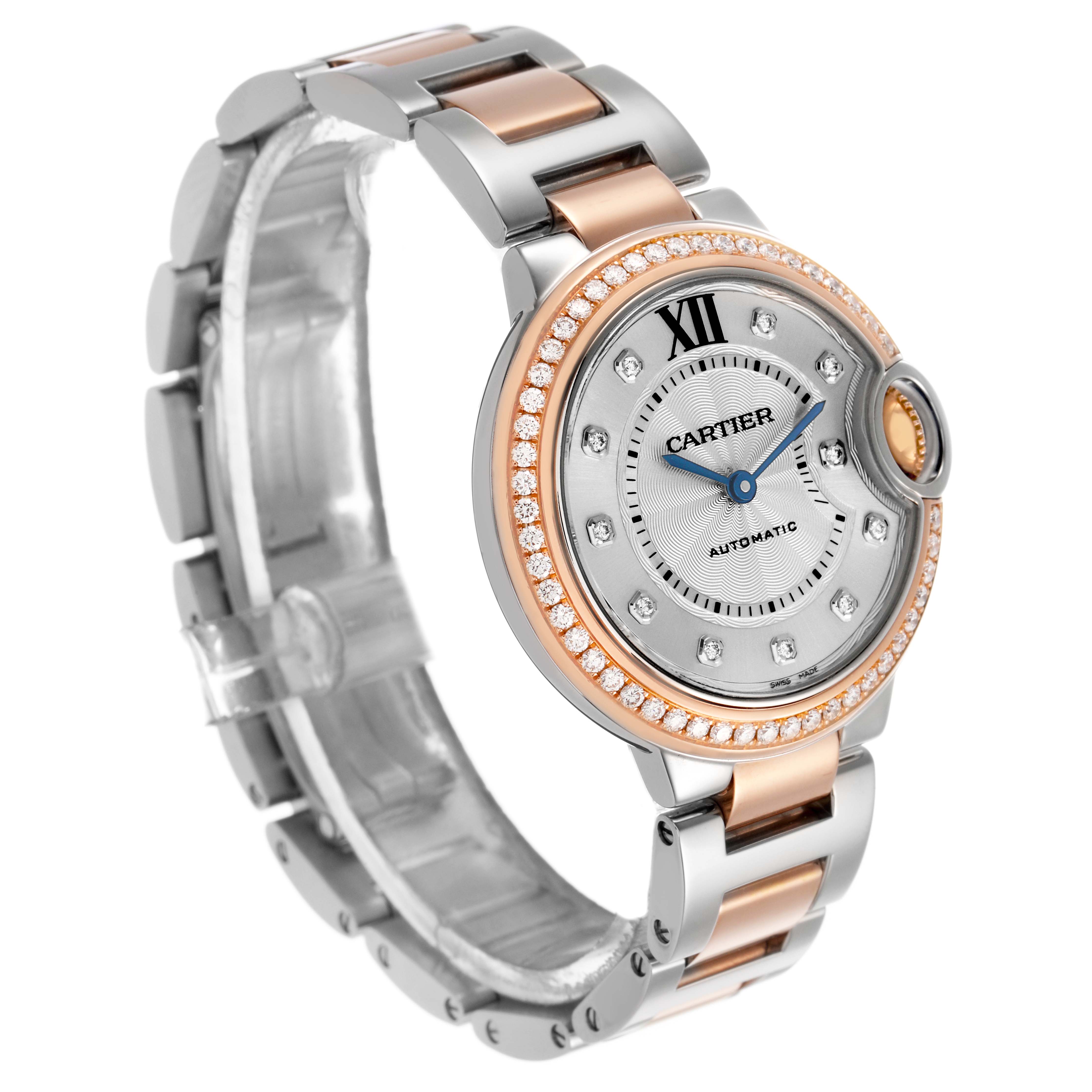 The Cartier Ballon Bleu WE902077 Women's Steel and Gold (two tone) Silver Dial watch is shown at a three-quarter angle, highlighting its face, bezel, bracelet, and crown.