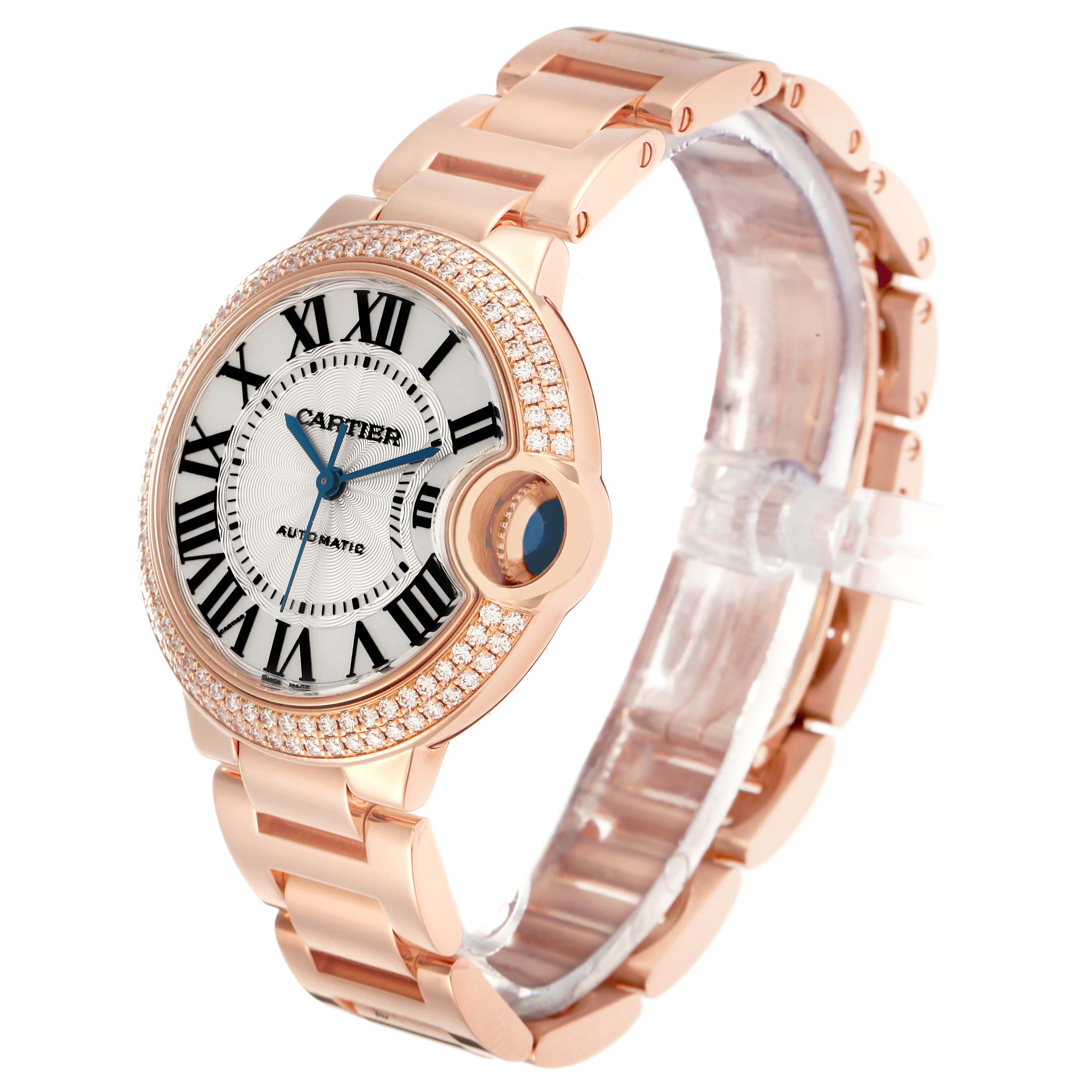 The Cartier Ballon Bleu model WE902034 men's watch is shown at an angle highlighting the rose gold bracelet, diamond bezel, and distinctive sapphire crown.