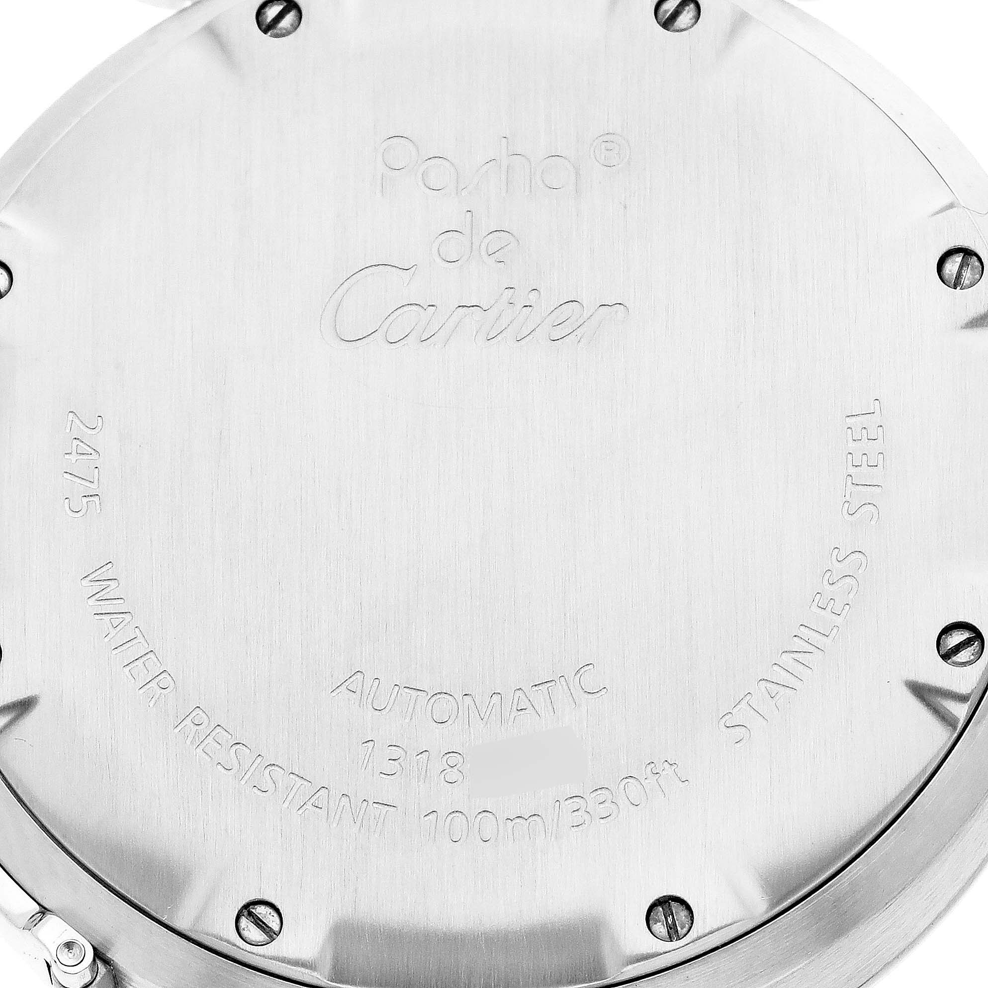 This image shows the back case of a Pasha model watch by Cartier, featuring engraved inscriptions and screws.